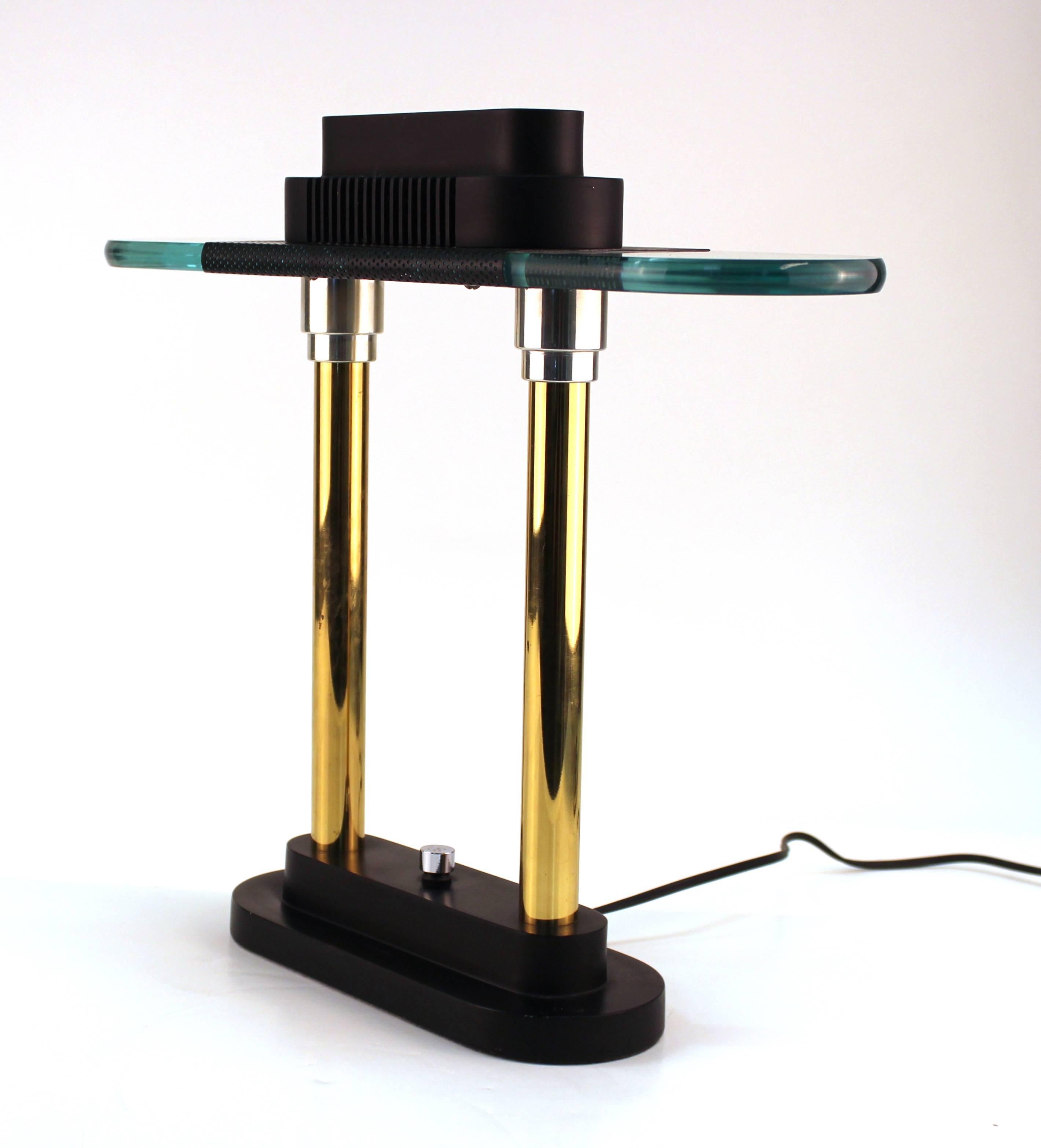 Robert Sonneman for George Kovacs table or desk lamp dating from the 1980s. Crafted with stepped top and base in black lacquered metal connected by a pair of brass pillars with chrome accents. Features also include a pair of glass 'wings' with