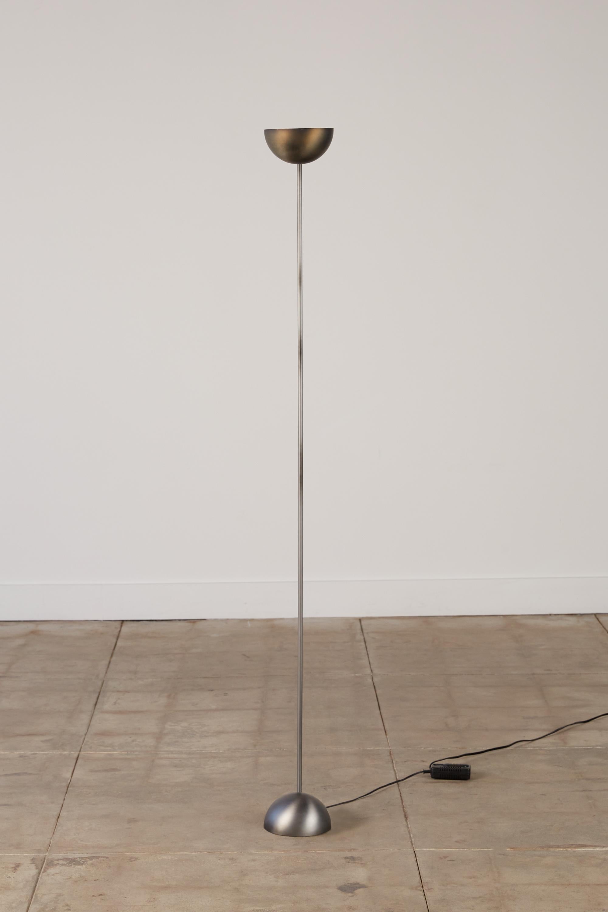 Postmodern torchiere floor lamp by George Kovacs in a brushed metal finish. The lamp uses an exposed half-sphere as both its base and shade and held together but a long thin stem. The lamp retains its original wiring.

George Kovacs is one the