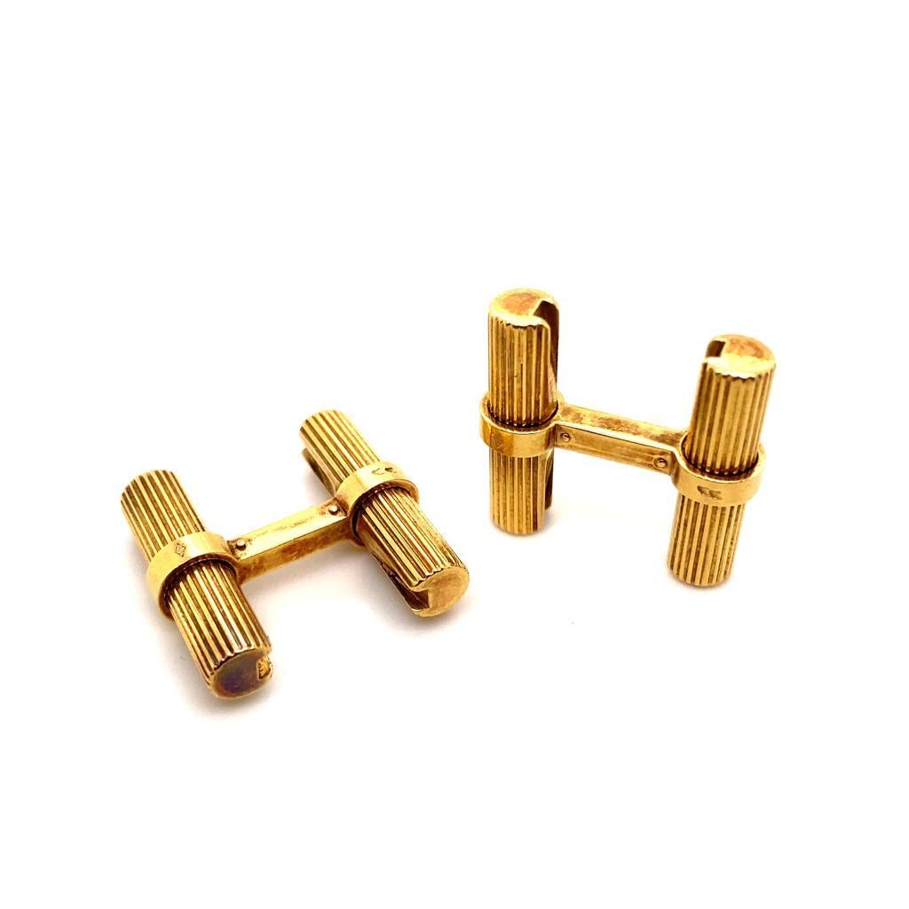 A pair of George L'enfant 18 karat yellow gold T-Bar cufflinks, circa 1960.

These smart vintage cufflinks feature two 18 karat yellow gold batons detailed with fine vertical engraved striations between T-bar fittings.

The solid and secure yellow