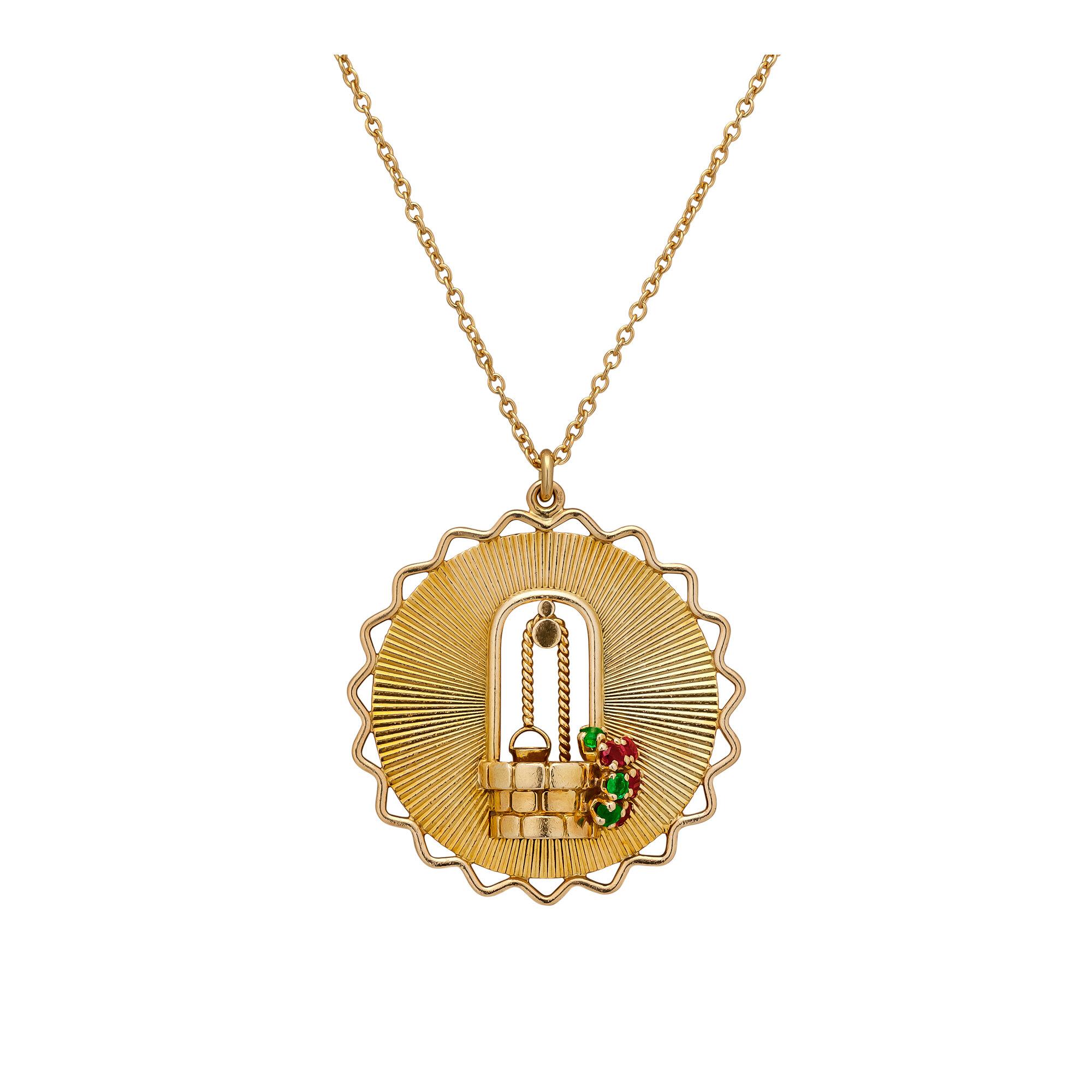 Make a wish wherever you go with this George L'Enfant Paris Tiffany & Co. vintage gold wishing well charm pendant necklace.  With a three dimensional wishing well blooming with ruby and emerald flowers, this sunny 18 karat yellow gold disc will make