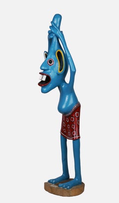 Sculpture of a blue figure / - Grown over the head -