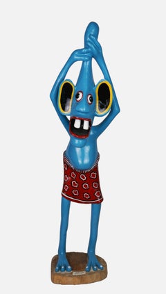 Sculpture of a blue figure / - Grown over the head -