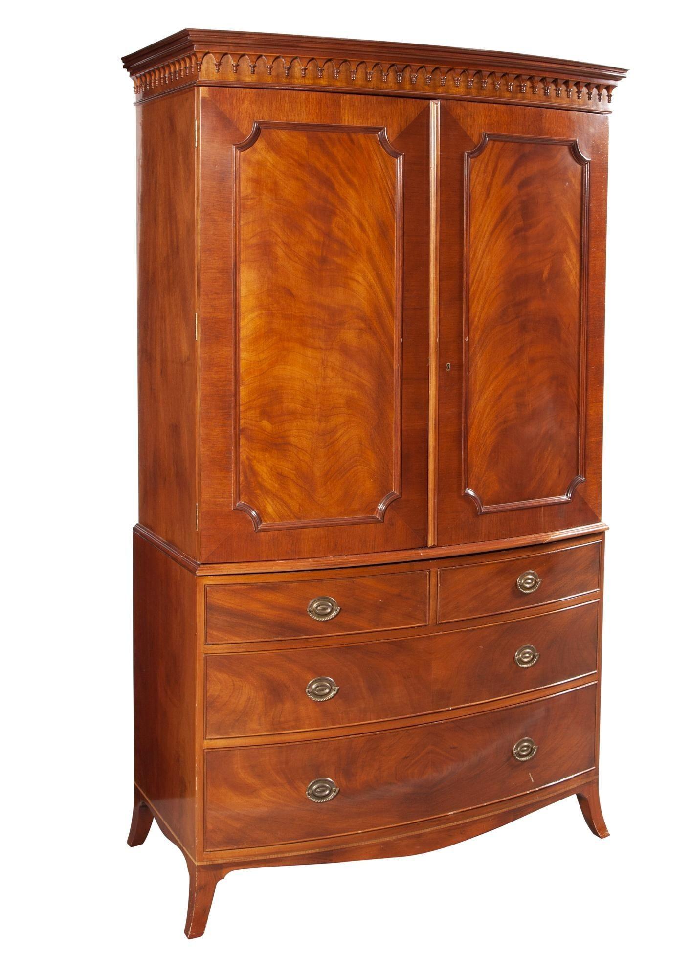 George lll Style Mahogany Armoire, Wardrobe, Linen Press, Schmieg & Kotzian
 
A stunning flame mahogany Bow Front Linen Chest or wardrobe cabinet possibly by Schmieg and Kotzian. The sprayed leas supporting an upper chest of drawers having two clean