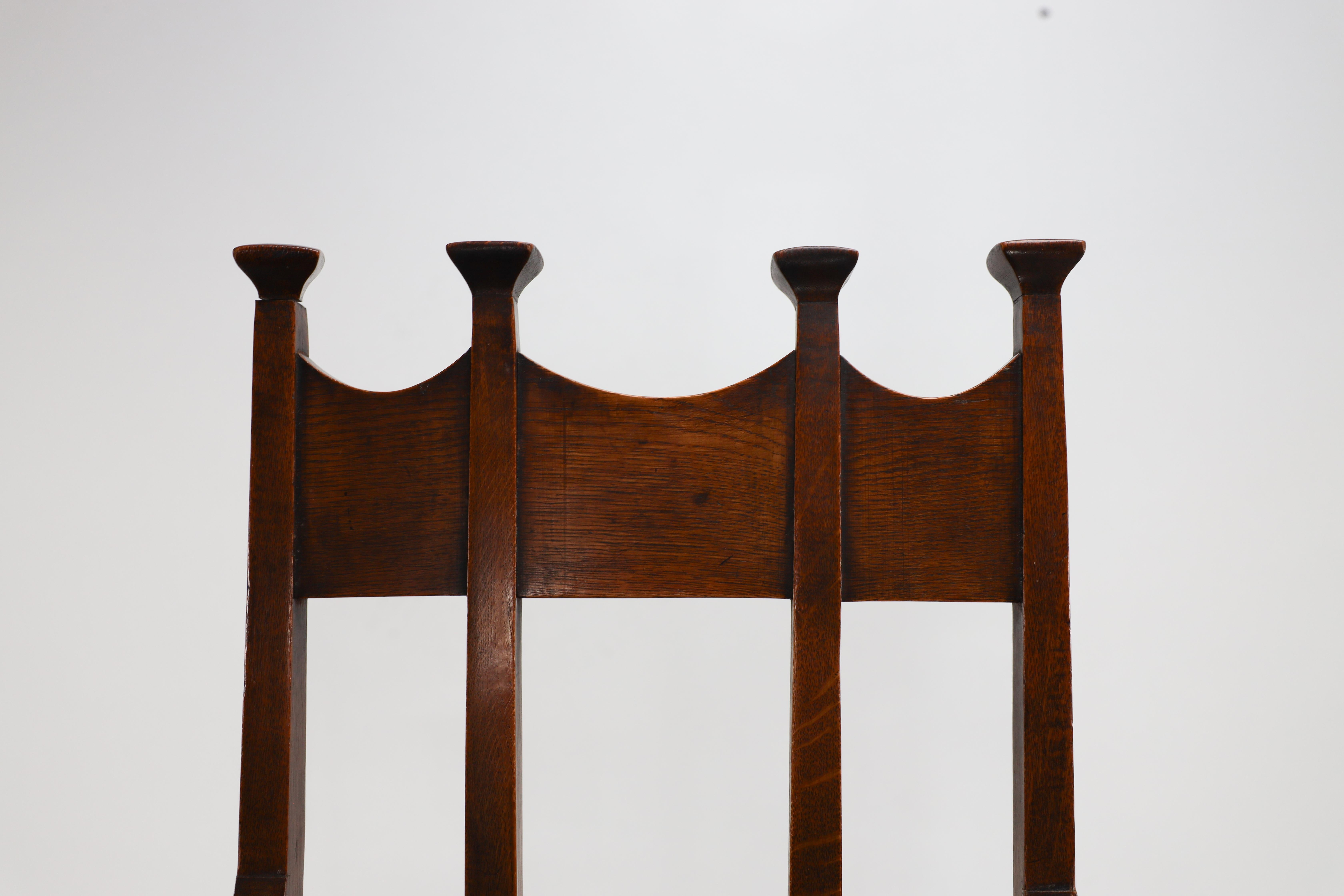 George Montague Ellwood. Made by J S Henry. A rare set of ten oak dining chairs. For Sale 10