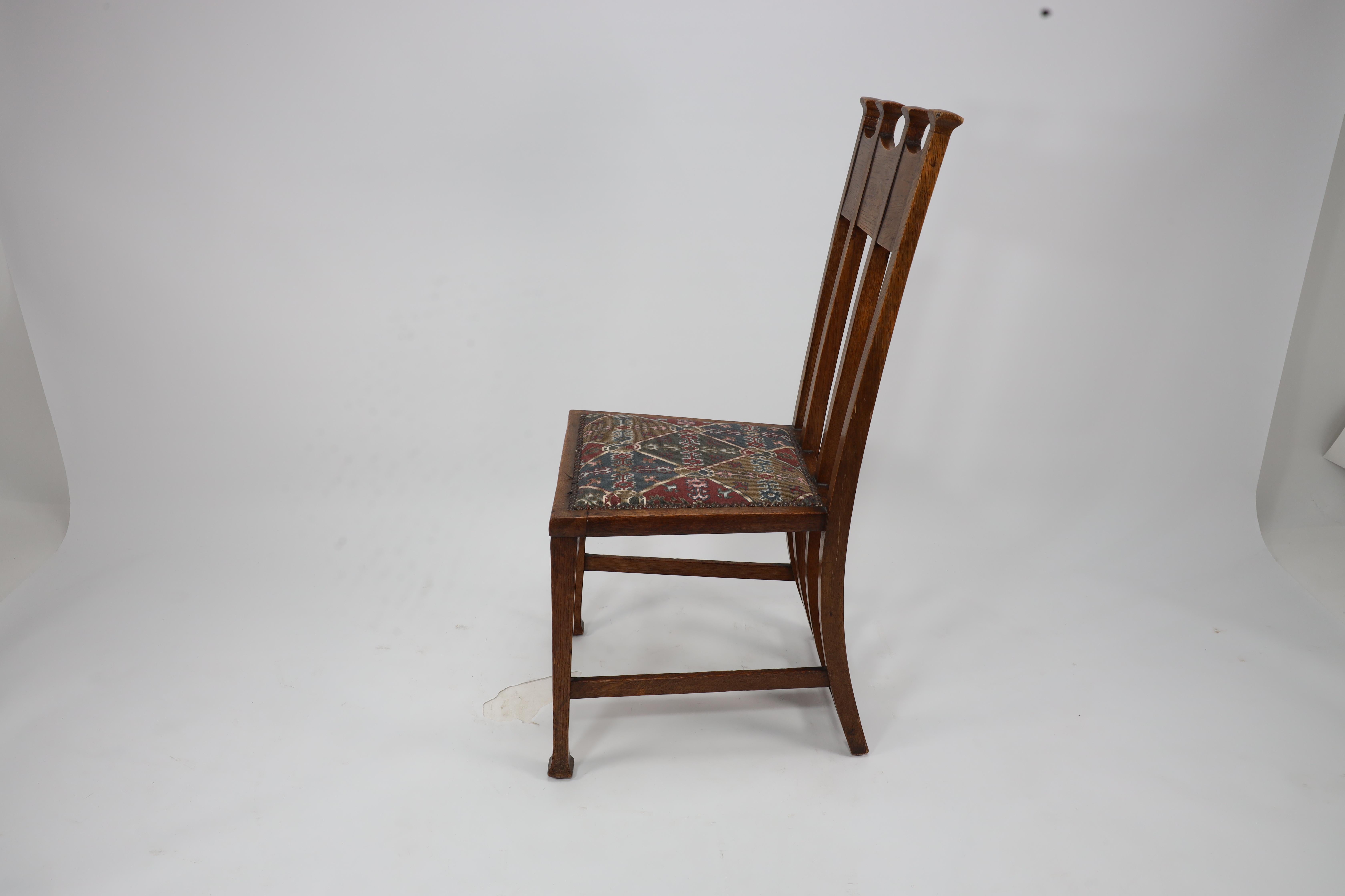 George Montague Ellwood. Made by J S Henry. A rare set of ten oak dining chairs. In Good Condition For Sale In London, GB
