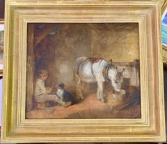 19th century Victorian English Boy seated in a barn feeding his dog and donkey