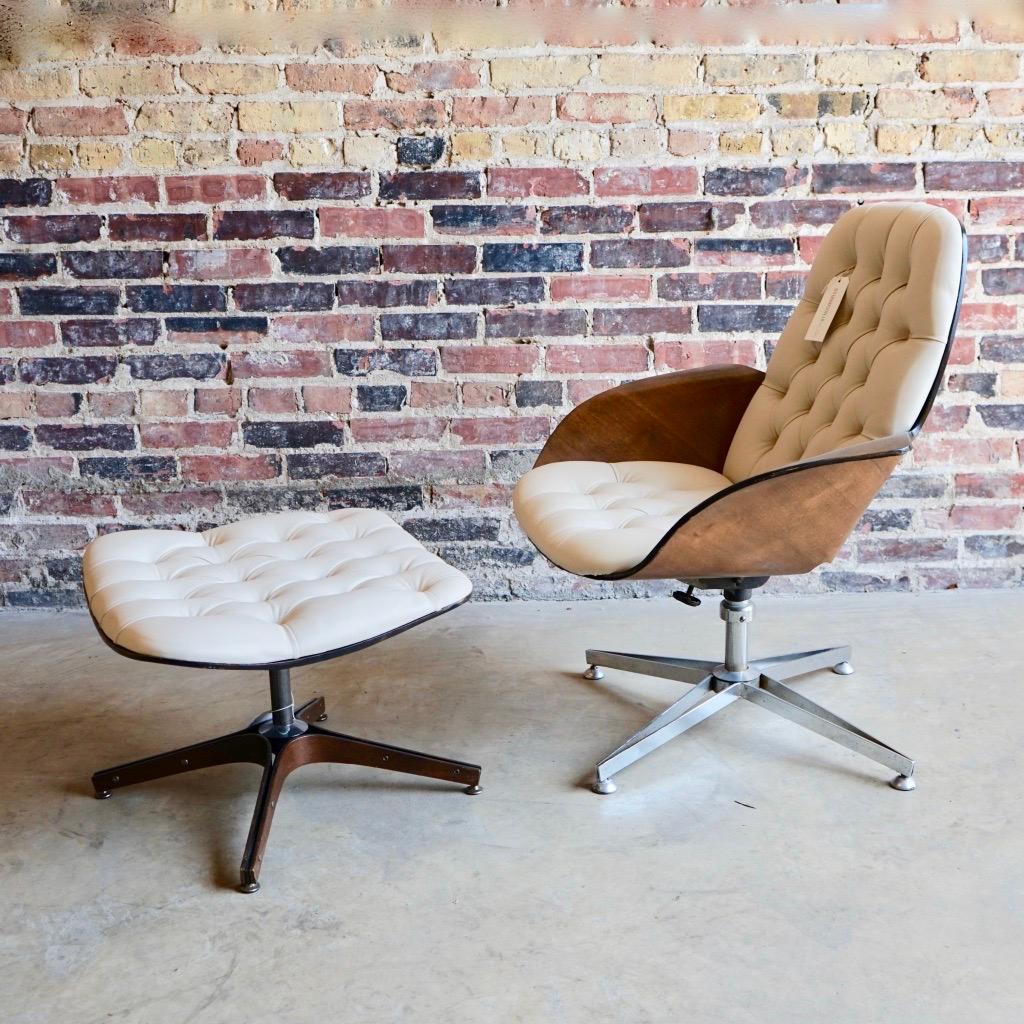 A 1960's molded plywood lounge chair and ottoman by George Mulhauser. The chair features stylish wing-like arms, tufted cream uber soft colored vinyl, and a swivel base. The chair was restored and reupholstered.  The base of the chair and the base