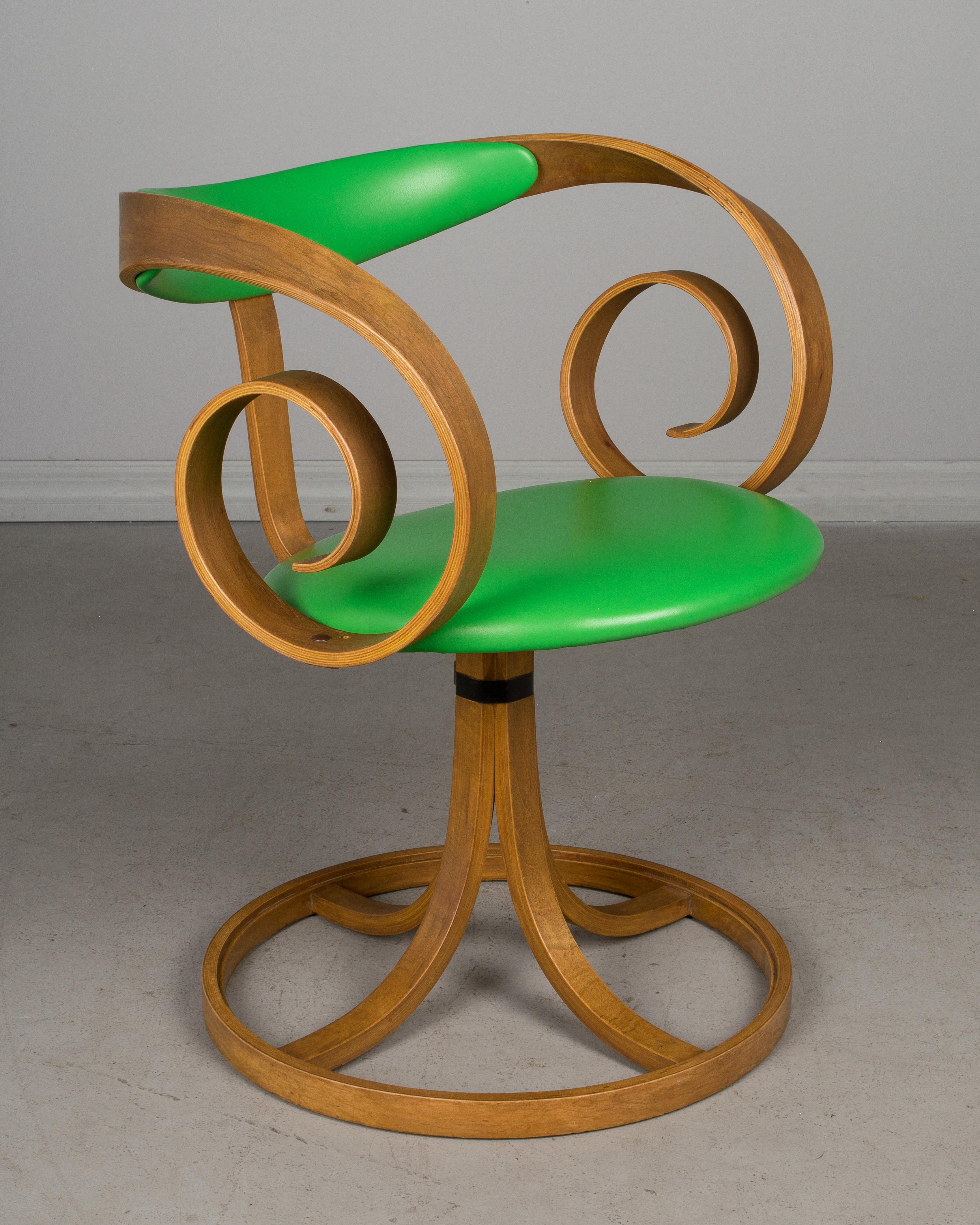 A Mid-Century Modern Sultana swivel chair designed by George Mulhauser for Plycraft. Bent plywood frame with scroll arms and sturdy pedestal base. Original bright green vinyl seat and backrest. Missing an enameled nailhead on one of the arms.