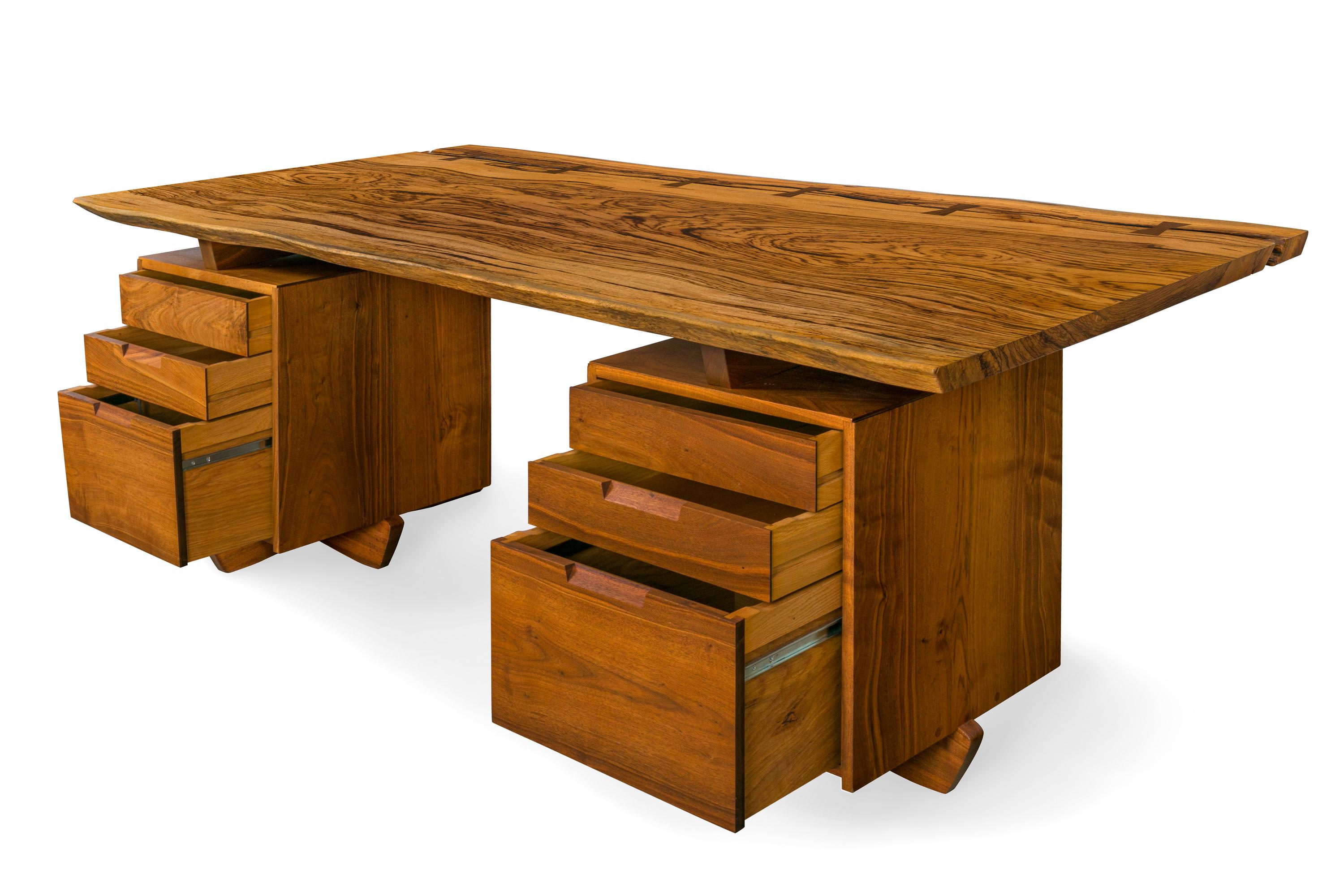 A magnificent example of George Nakashima's work. Commissioned directly from the artist by the previous owner in 1985 and executed in 1986. The desk is signed and dated by George Nakashima, July 18, 1986 with the original owner's name and dedication.
