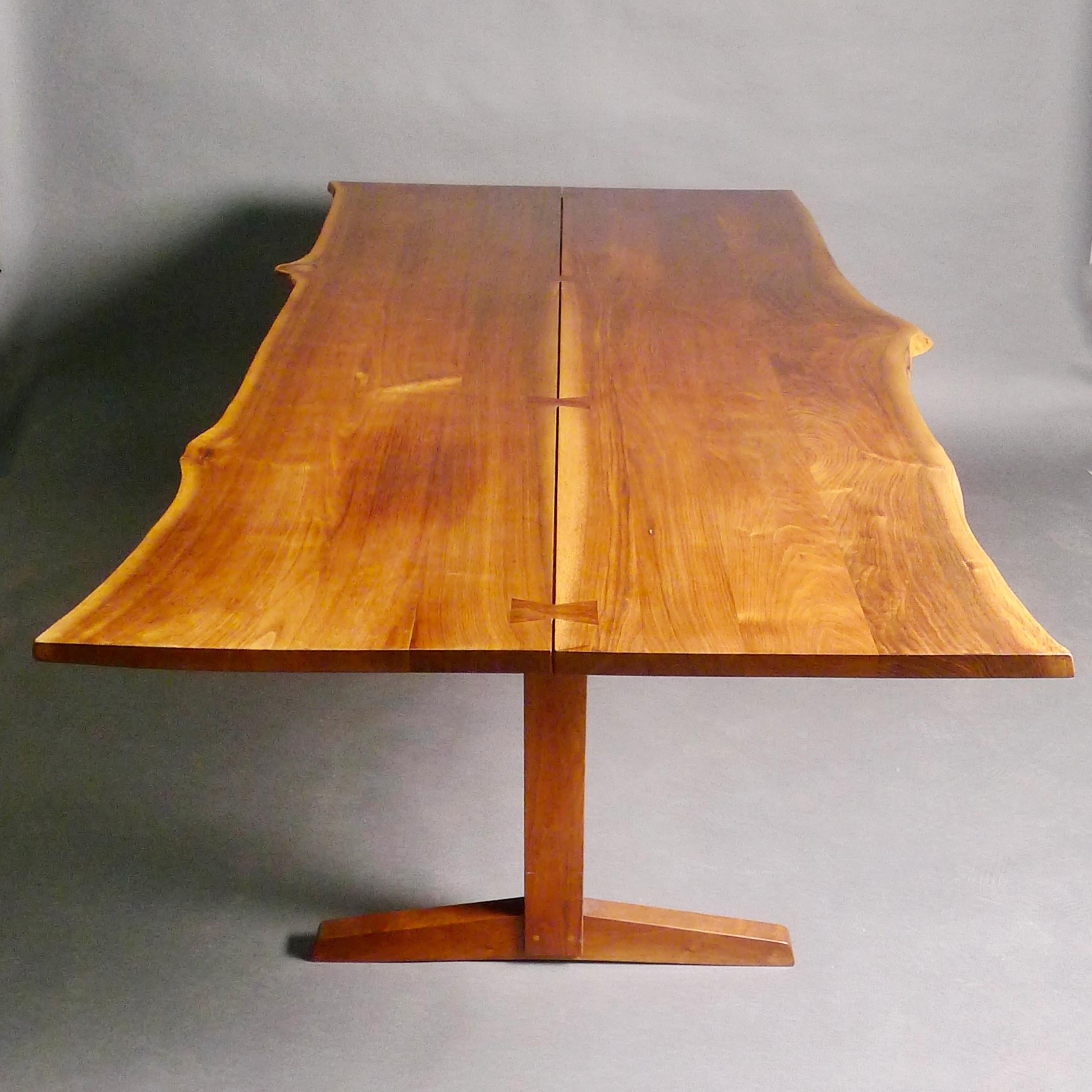 George Nakashima (1905-1990)
American black walnut trestle dining table, with book-matched top featuring four rosewood butterflies and free edges.
made at the Nakashima Studio, Philadelphia USA, 1960
74cm high, the top 213 × 114 cm (narrowing to