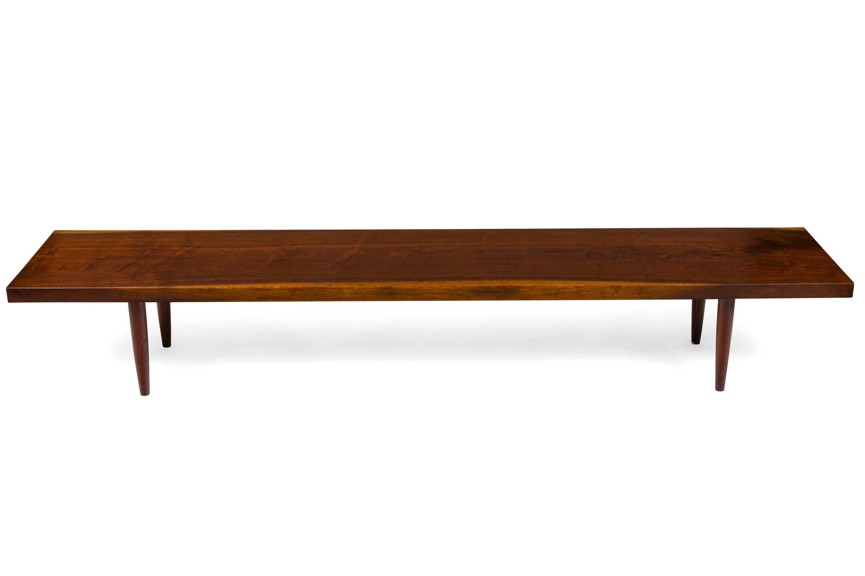 Another of George Nakashima's simple but brilliant early designs. Solid and sturdy this slab bench could function in a variety of settings including as a coffee table.