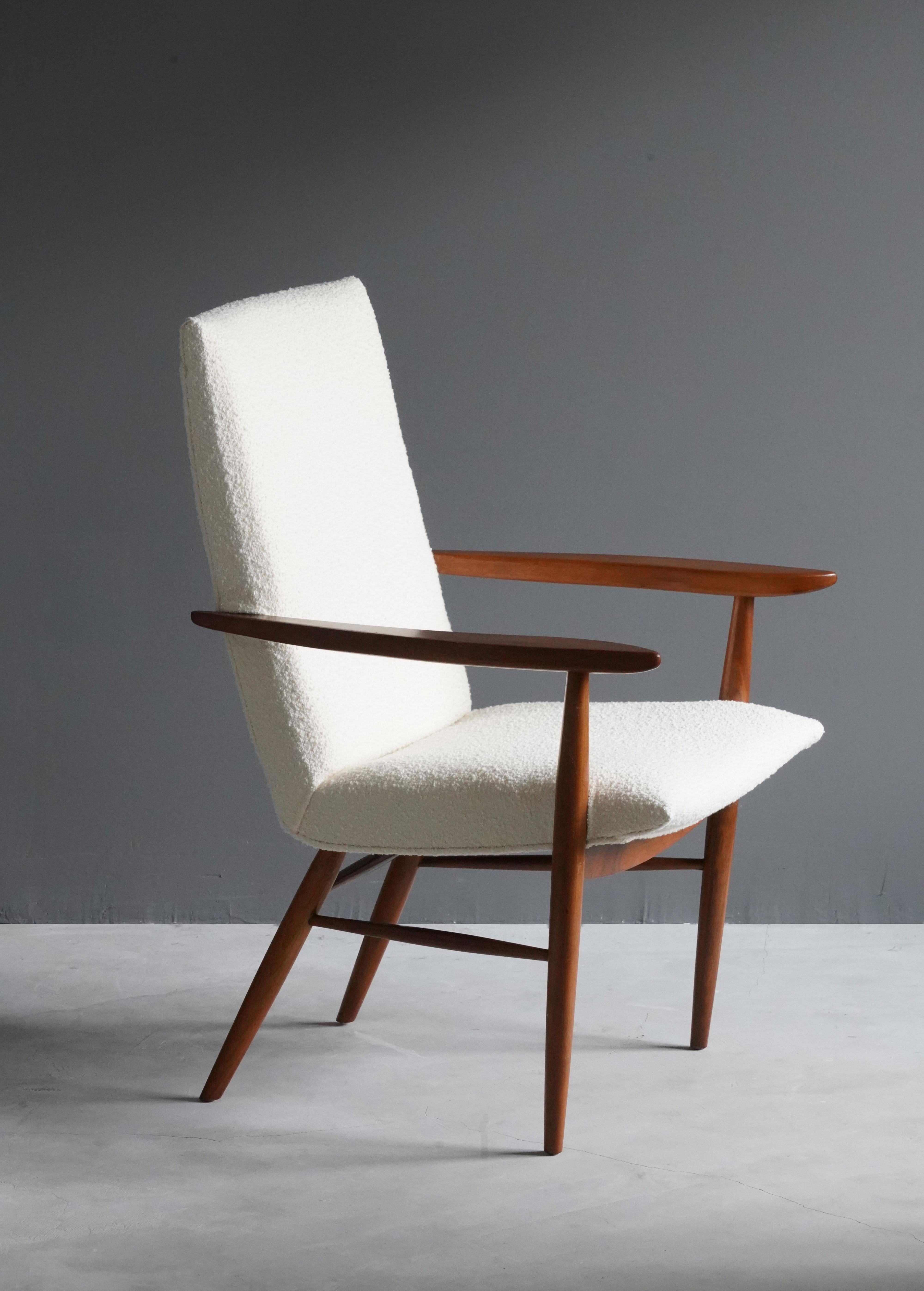 An arm chair / side chair, designed by George Nakashima, produced by Widdicomb Furniture Company, Grand Rapids, Michigan, America, 1960s.

Features finely turned walnut, overstuffed seat reupholstered in Knoll Bouclé fabric.