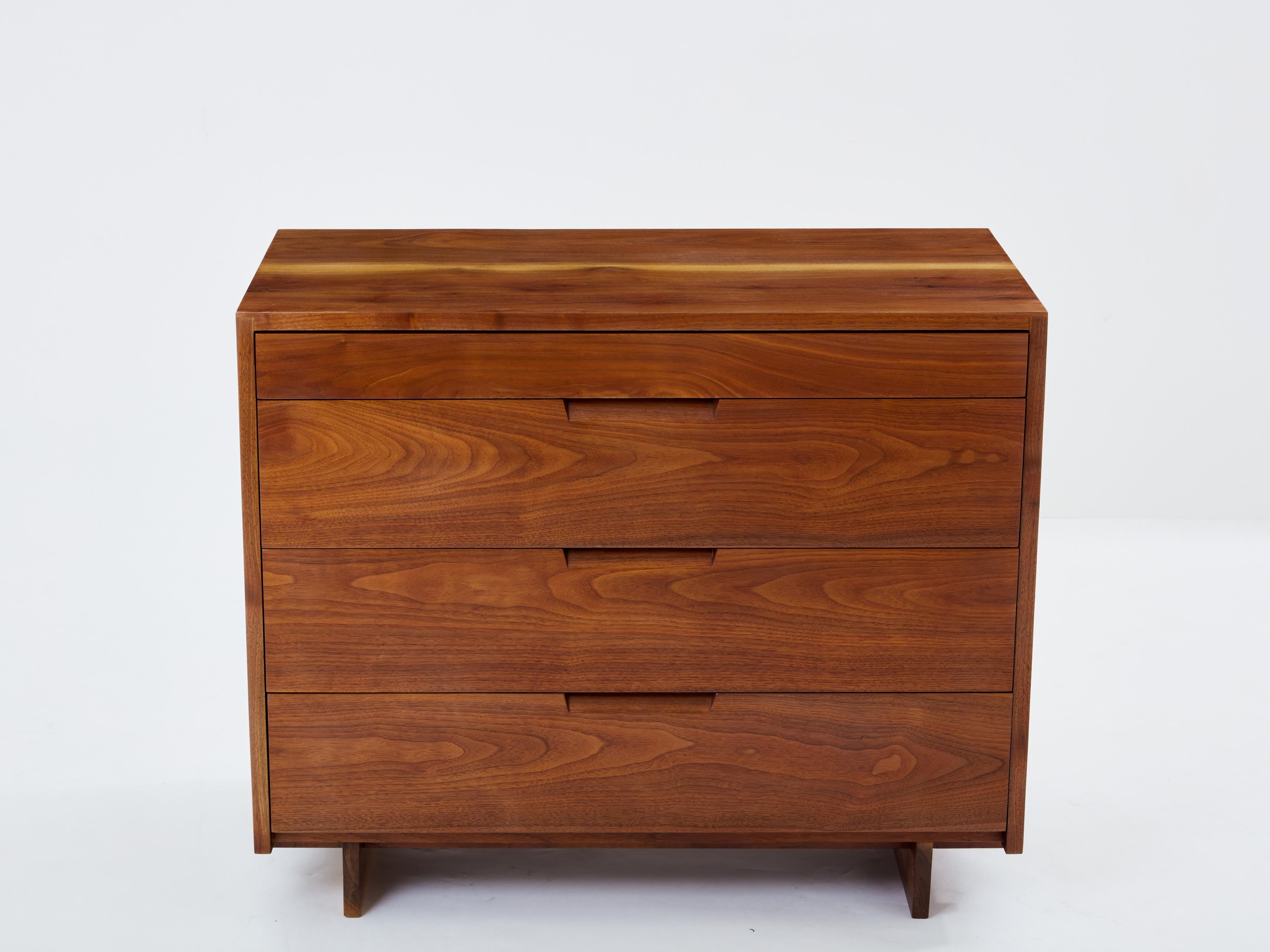 This dresser crafted from American black walnut is a stunning testament to George Nakashima's craftsmanship. Created upon the request of a private client in 1955, the angular shapes of the piece and its sleek structure allow the wood, Nakashima's