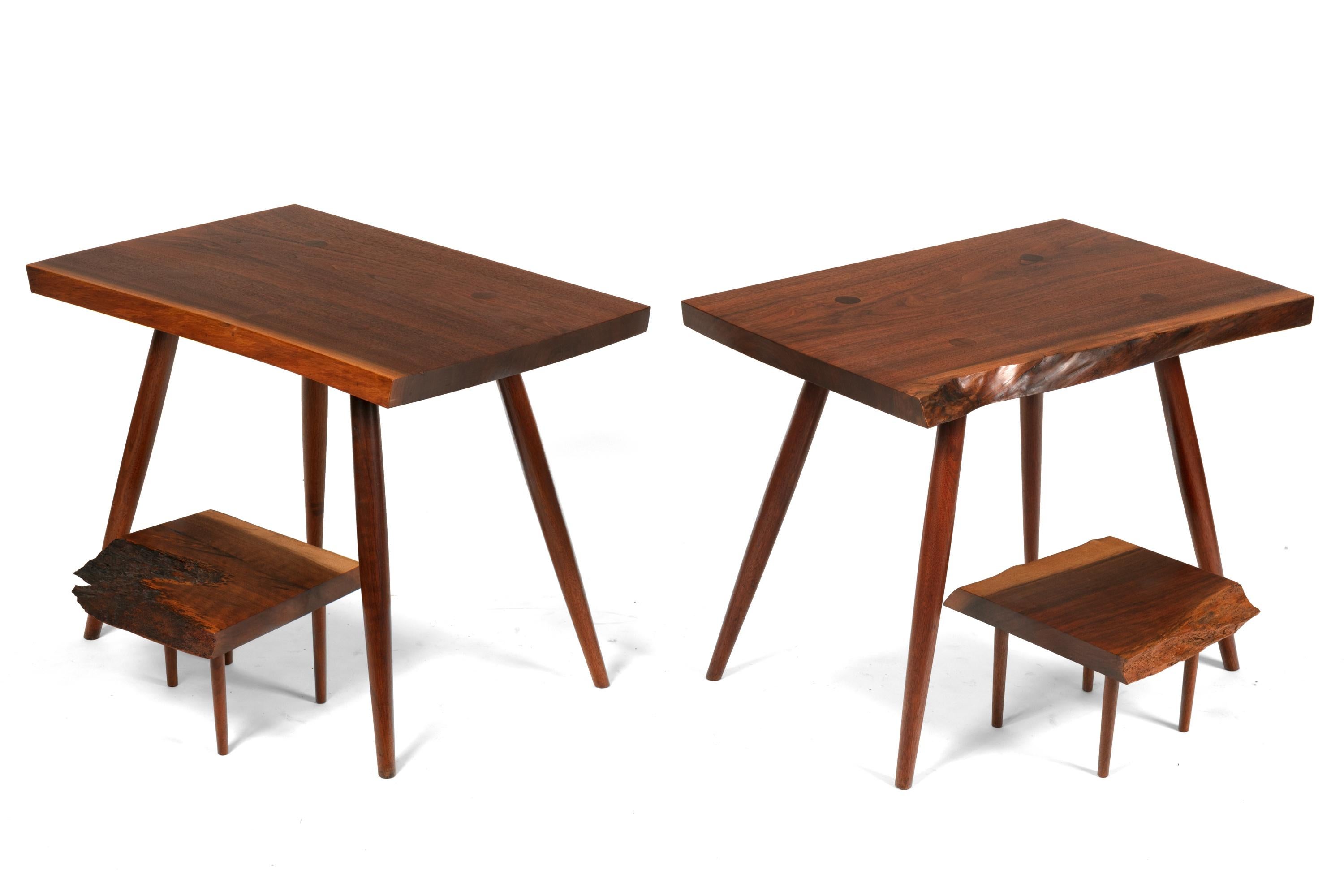 An unusually versatile pair of Nakashima tables. The second tier is free to be repositioned on the tabletop.