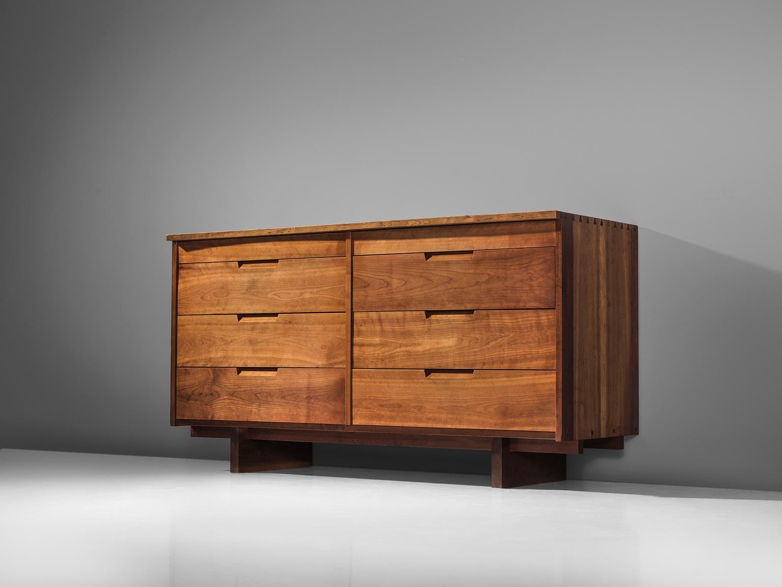 George Nakashima, cabinet in cherry, New Hope, PA, 1960s - 1970s.

This cabinet features eight drawers, executed in cherry with traditional and finished with archetypical dovetail Nakashima wood-joints. The cabinet rests on two slabs of solid