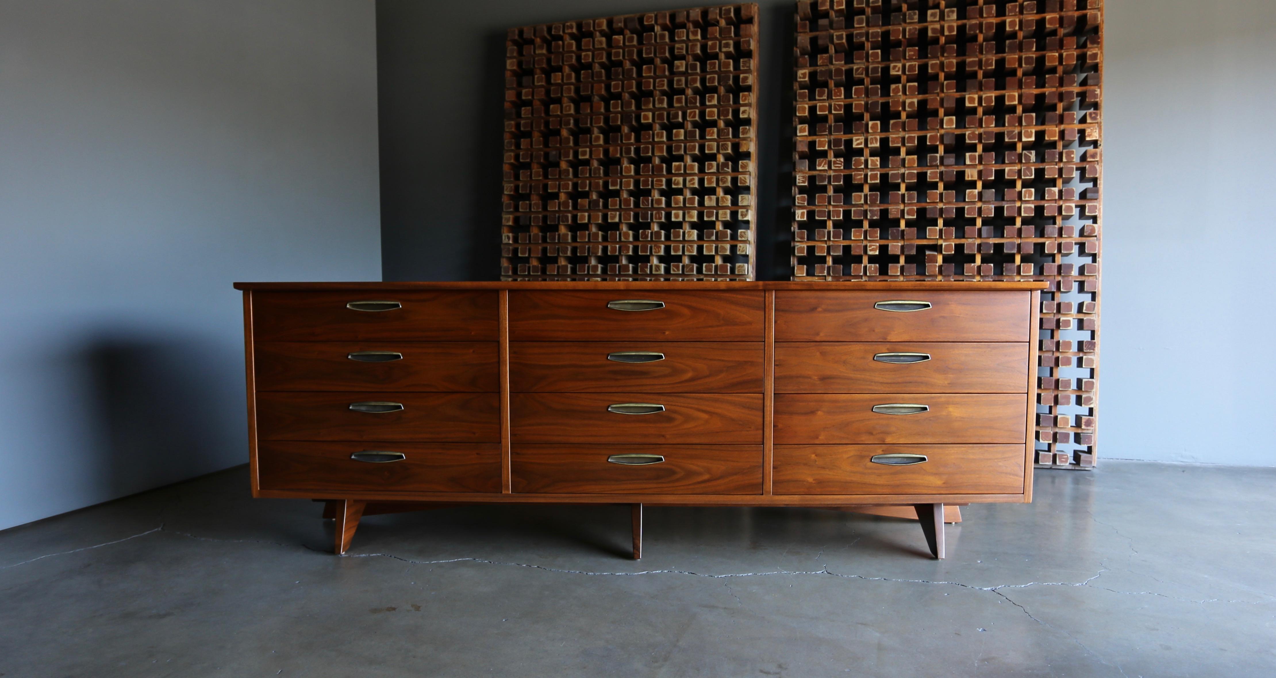 George Nakashima 12 - drawer dresser for Widdicomb, circa 1959. This piece has been professionally restored. Original patina to the brass hardware.