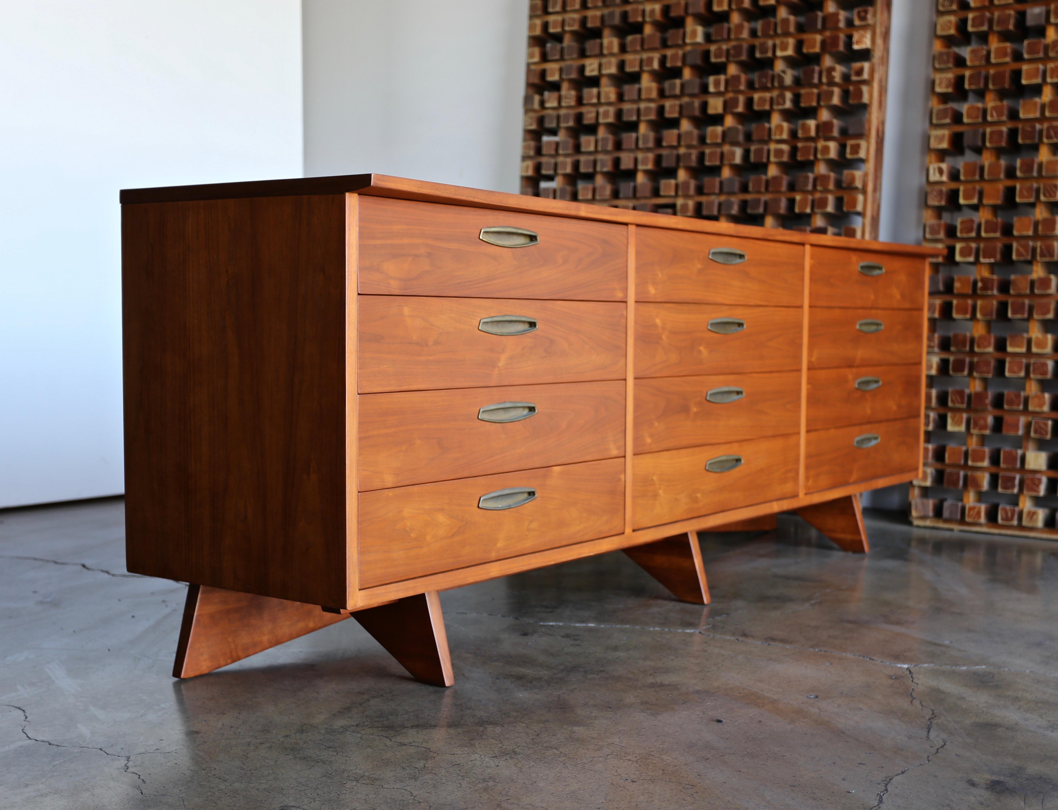 George Nakashima 12 - drawer chest for Widdicomb, circa 1955. This piece has been professionally restored. Original patina to the brass hardware.