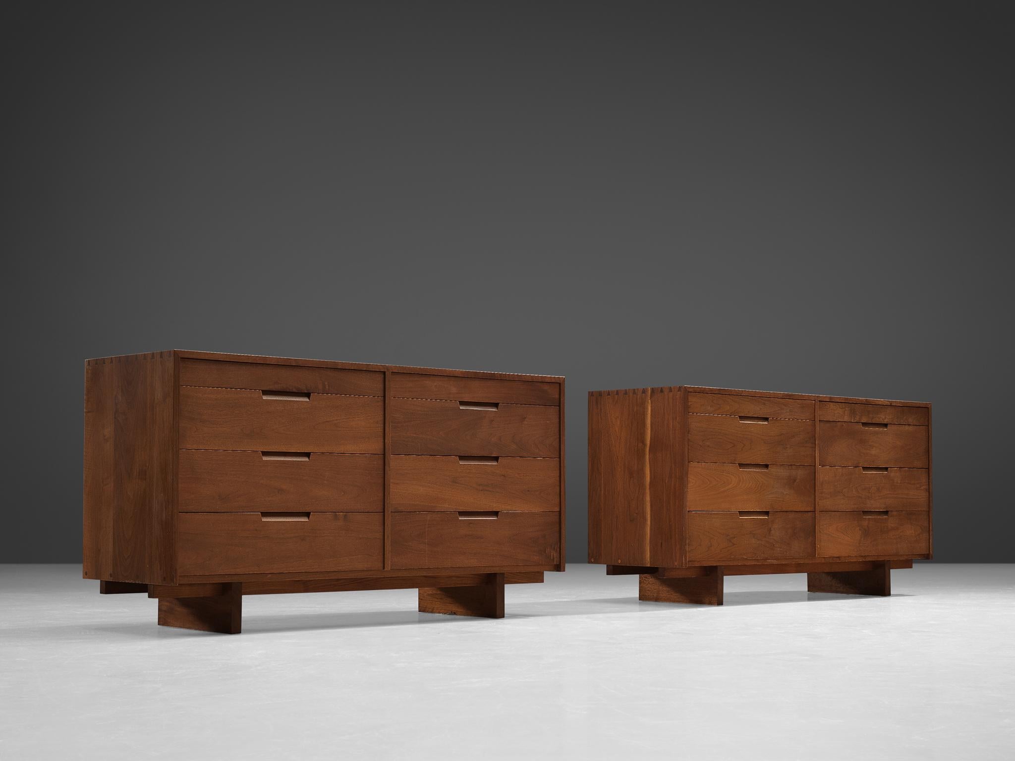 George Nakashima, pair of cabinets in walnut, New Hope, PA, 1955.

These sideboards feature eight drawers each, executed in walnut with traditional and finished with archetypical dovetail Nakashima wood-joints. The cabinets rest on two slabs of