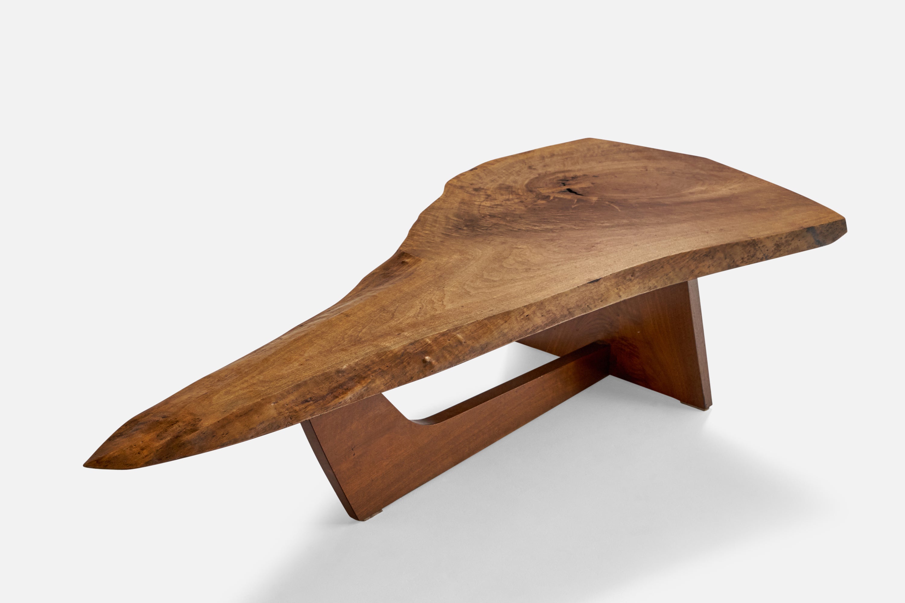 An American black walnut coffee table designed by George Nakashima and produced by Nakashima Studio, New Hope, Pennsylvania, United States, 1982. 

 