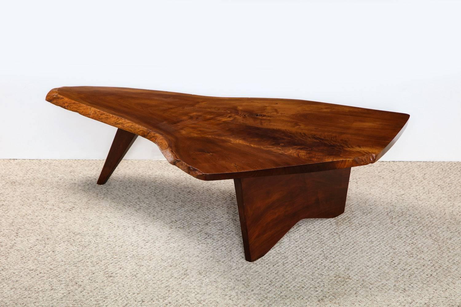 Slab coffee table by George Nakashima. American black walnut triangular top, all sides with free edge.