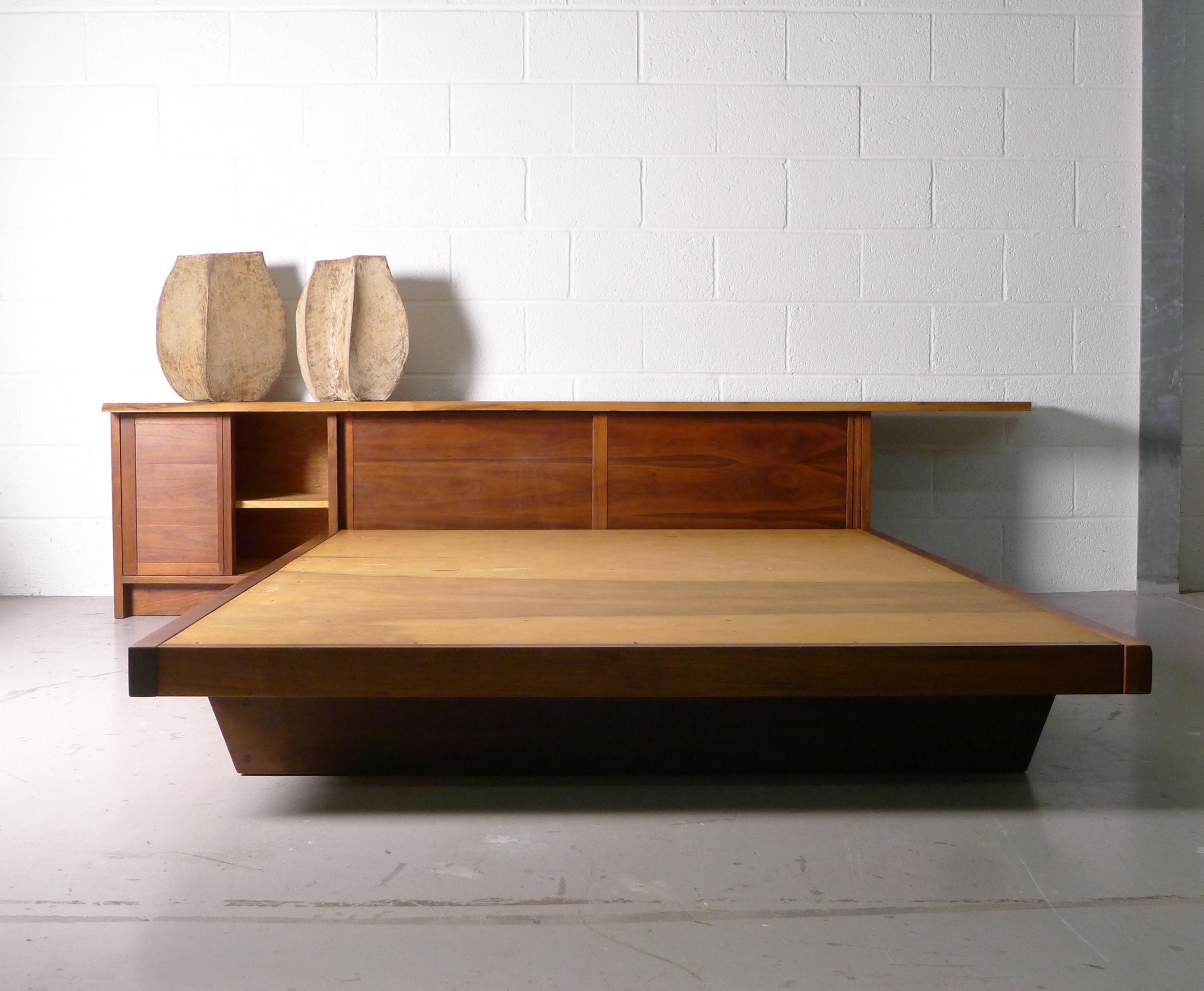 George Nakashima
Conoid headboard and Conoid platform bed
Nakashima Studio
USA, 1966
American black walnut
275cm wide x 62cm high, 108cm wide

Headboard measures 275cm wide x 62cm high x 49cm deep. 
Platform bed measures 152.5cm wide x 60cm high x