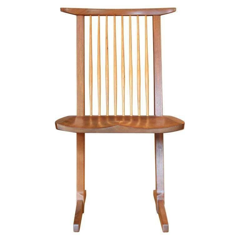 Set of 12 Conoid chairs by George Nakashima. Walnut with hickory spindles, original finish in excellent condition. Each chair signed on underside of seat. Willing to split set up into (2) sets of 6. 
