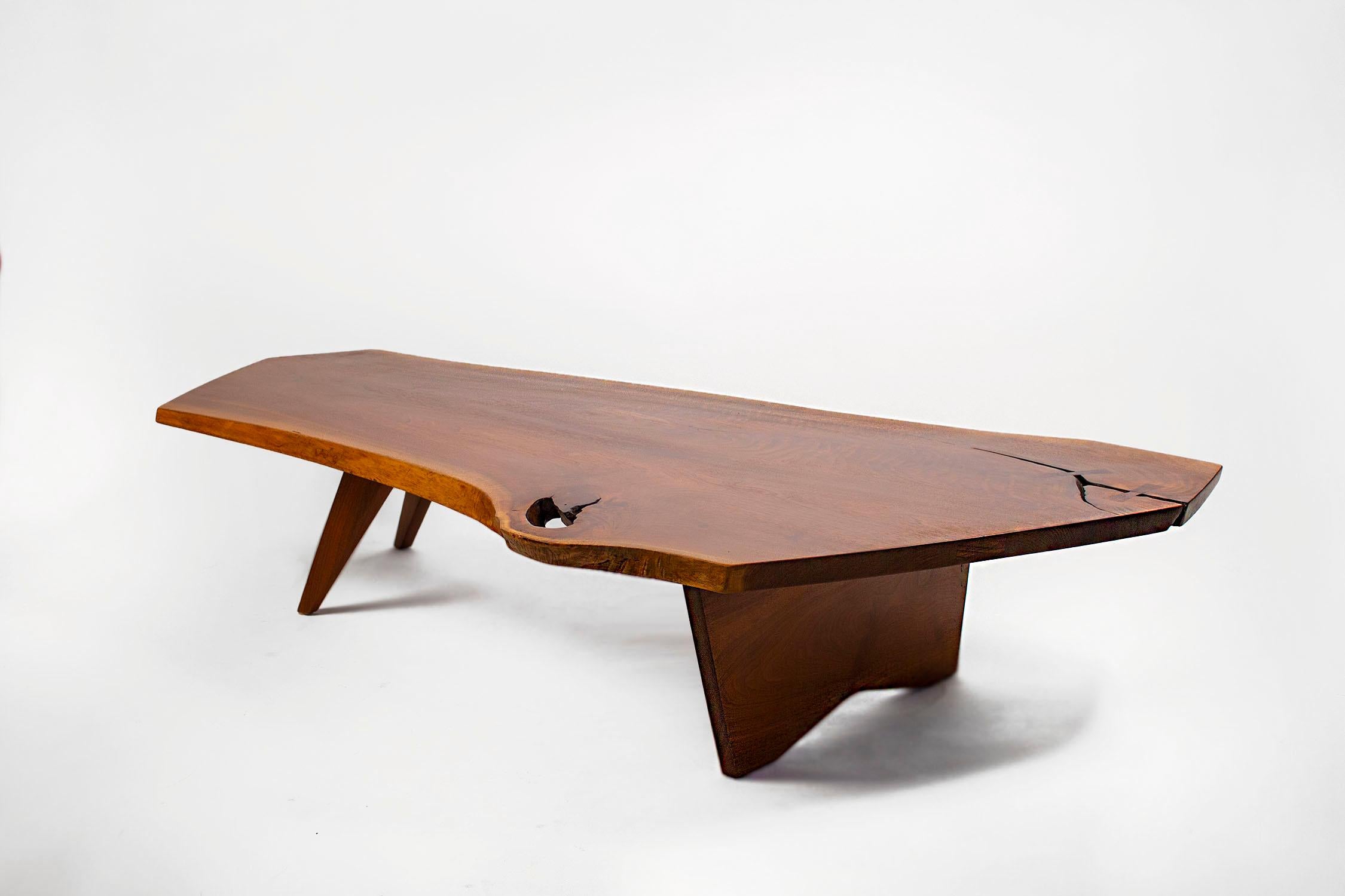 Custom ordered in 1963, this early George Nakashima Studio coffee table is one of the larger examples of this form measuring in at over six feet long.
The freeform edges are amazing. The stunning sap grain, the slight inclusion with the solid