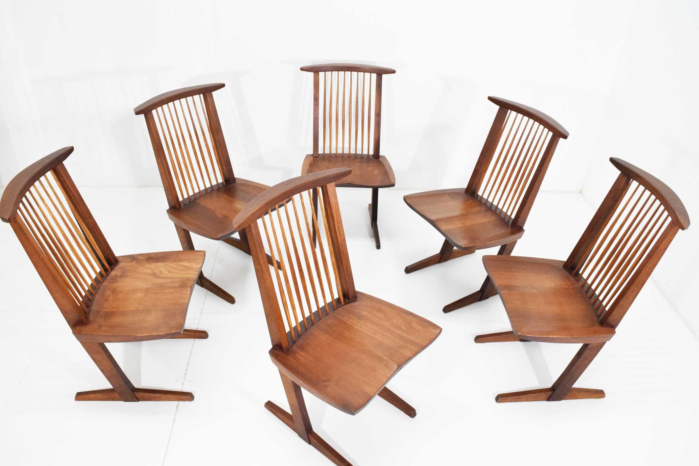 George Nakashima Conoid dining chairs in black walnut and hickory. New Hope, Pennsylvania, 1970s. Four signed with client's name 