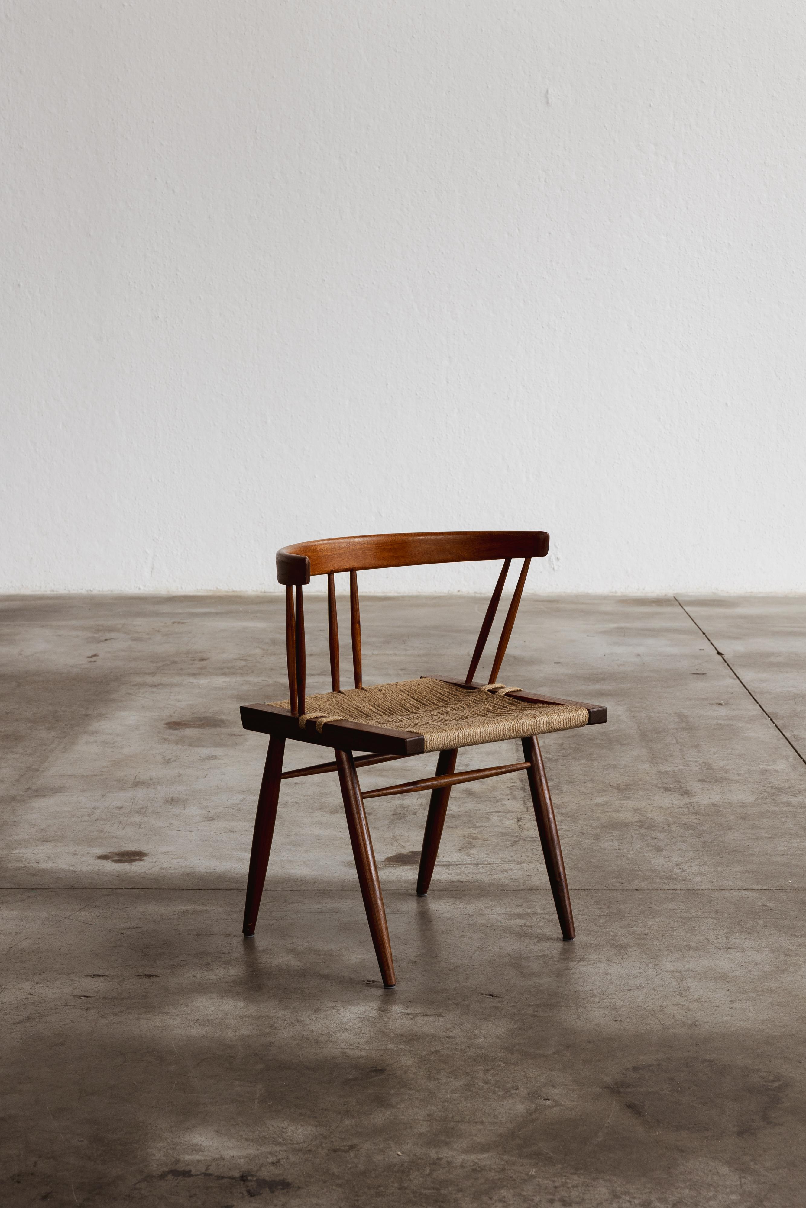 George Nakashima dining chair, seagrass and wood, USA, 1947.

George Nakashima designed these dining chairs in 1947, embodying a fusion of traditional Japanese woodworking and modernist design. Crafted from American black walnut, they feature a low,