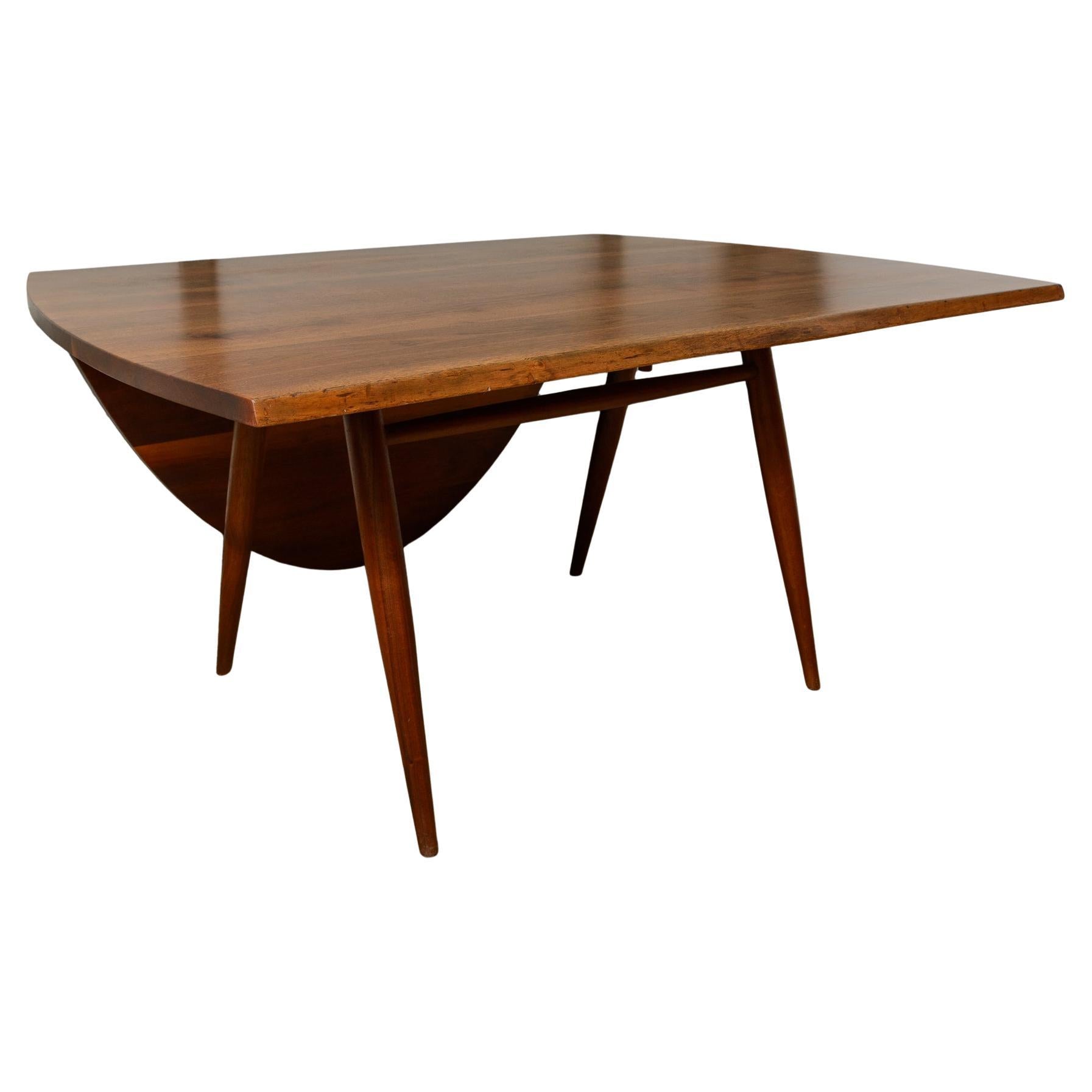 George Nakashima Drop Leaf Table
An unusual form featuring a large curved drop leaf and a free edge on the opposite side.
The table has 4 legs, with a 5th that slides into position  when the drop leaf is horizontal
From a large early family