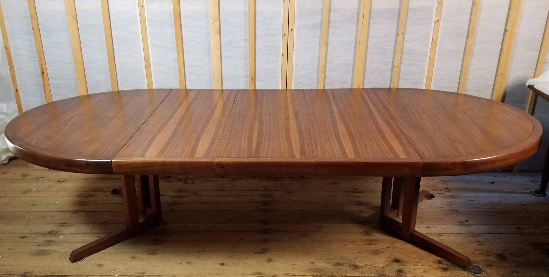 An extendable walnut dining table by George Nakashima for Widdicomb Furniture Company from 1960.
A line of book-matched veneers encased by a 3 inch deep carved and finger joined solid walnut edge gives the top of the table an interesting