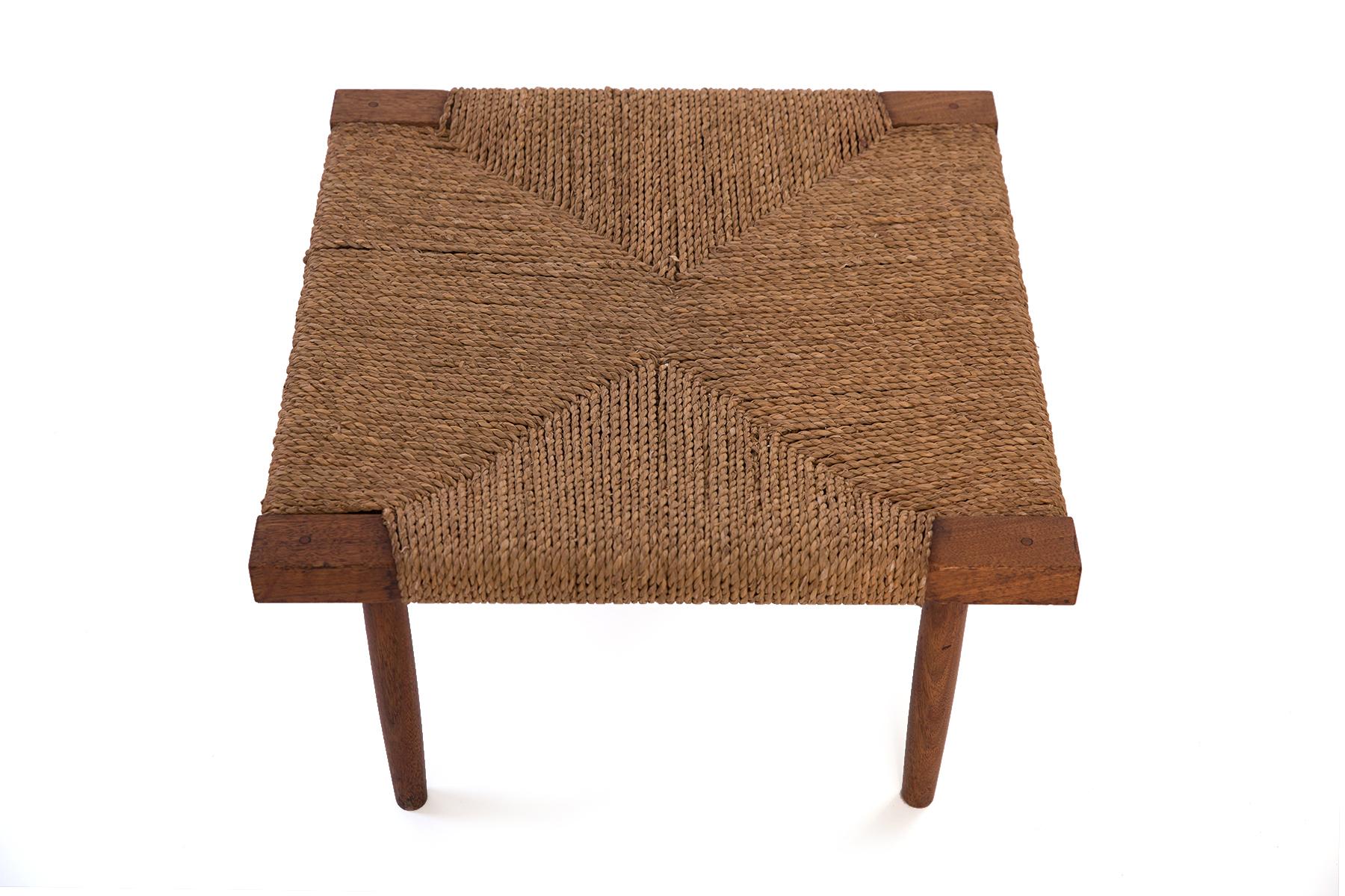 This is a fine all original example of George Nakashima's Fitch stool in walnut with grass cord seat, reflecting Nakashima's reverence for fine craftsmanship and natural materials.