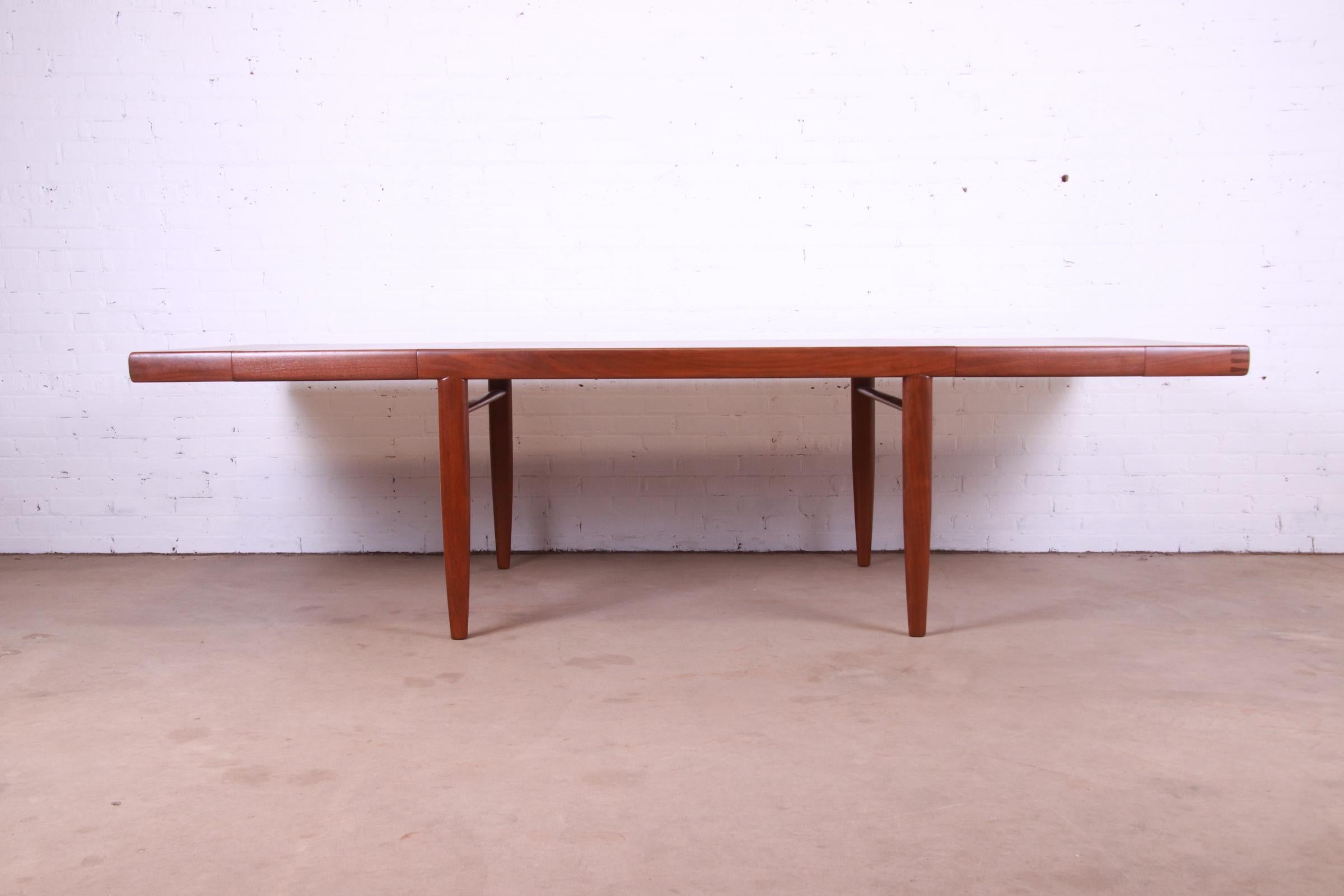 A very rare and exceptional mid-century modern extension dining table, featuring gorgeous walnut wood grain, a graceful Organic Modern design, and exposed dovetail joints at the corners.

By George Nakashima for Widdicomb Furniture, 