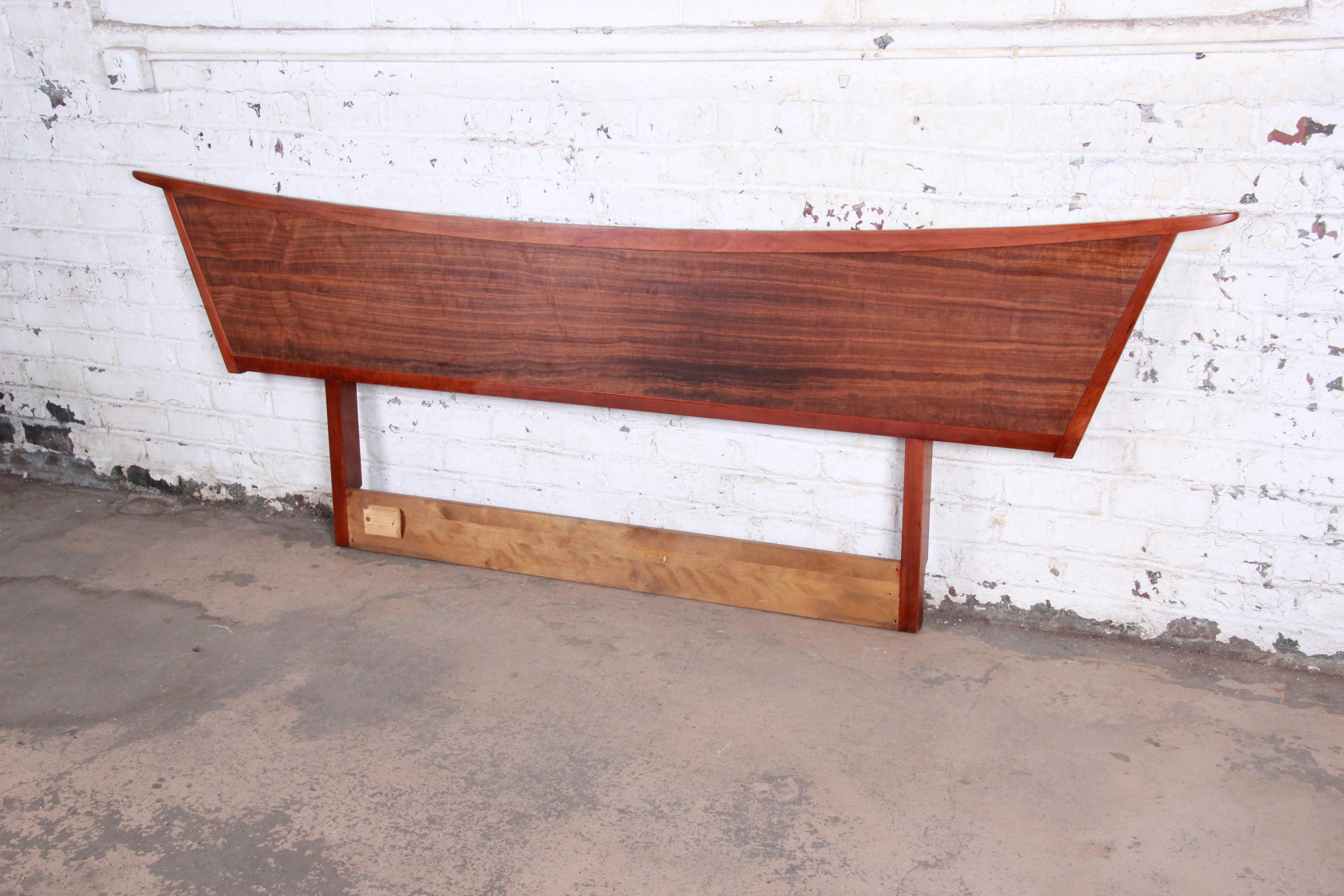 An extremely rare and outstanding Mid-Century Modern headboard from the Origins Collection by George Nakashima for Widdicomb Furniture of Grand Rapids. The headboard features a dramatic, sweeping form that is regal and elegant. The surface is