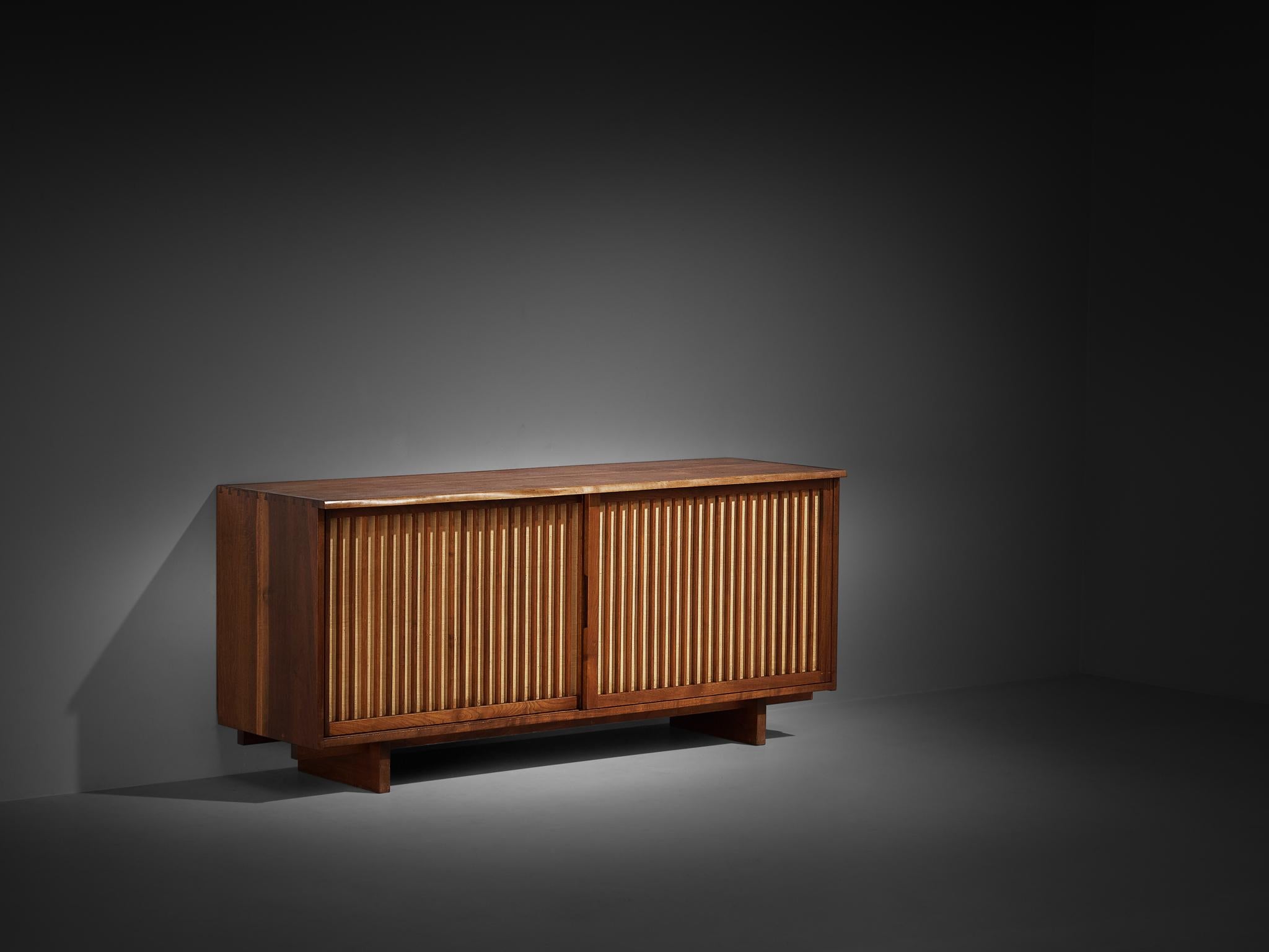 George Nakashima, free edge sideboard in American black walnut, pandanus cloth, United States, 1958

This fine free edge sideboard was designed by George Nakashima and created in his studio in New Hope, Pennsylvania. Described by the master