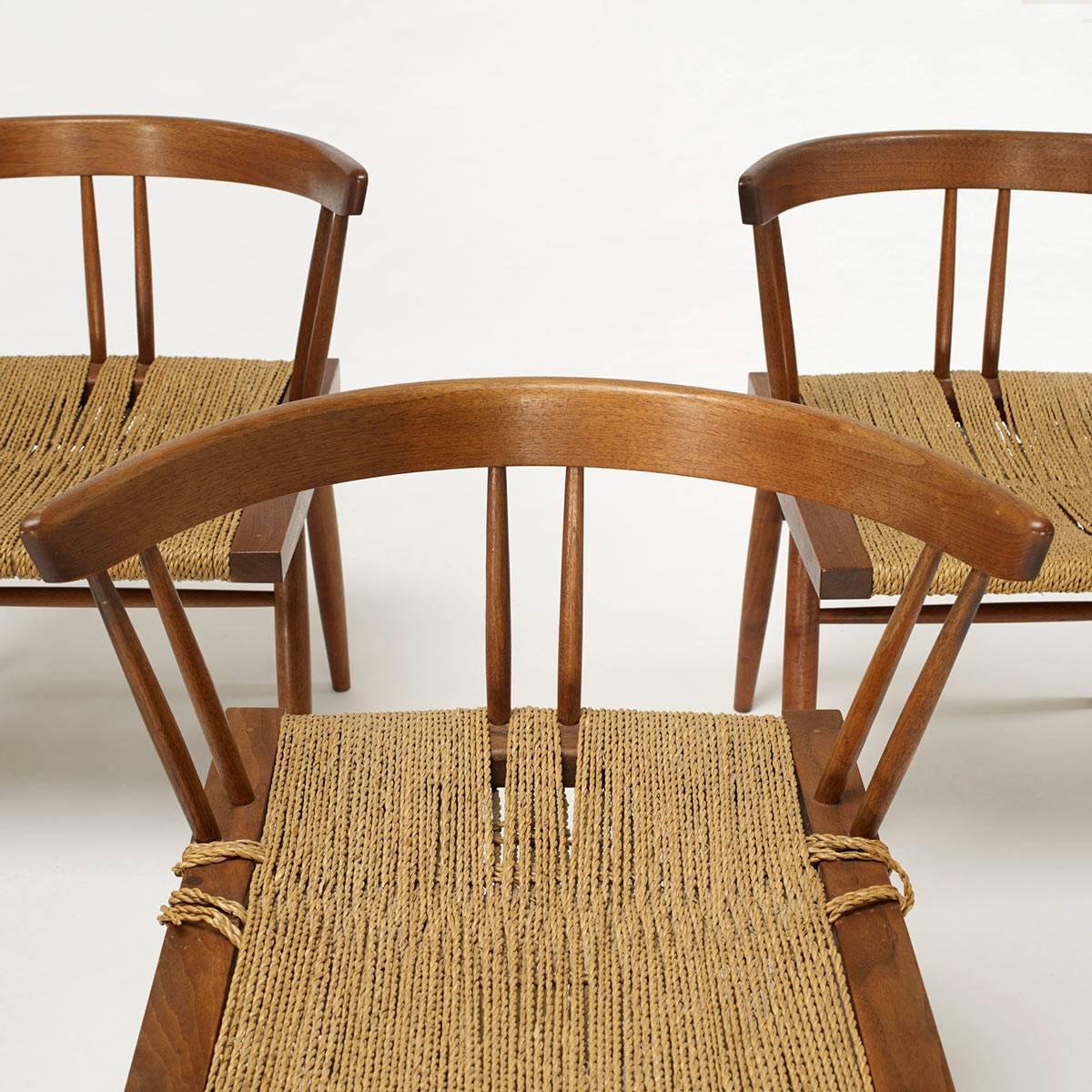 George Nakashima grass cord seat chairs with walnut frames. New Hope, PA, circa 1967.
Seats re-roped. Dark patina to likely original finish. Good condition.
Sold with a letter of authenticity issued by
Mira Nakashima.

Priced Individually, but can