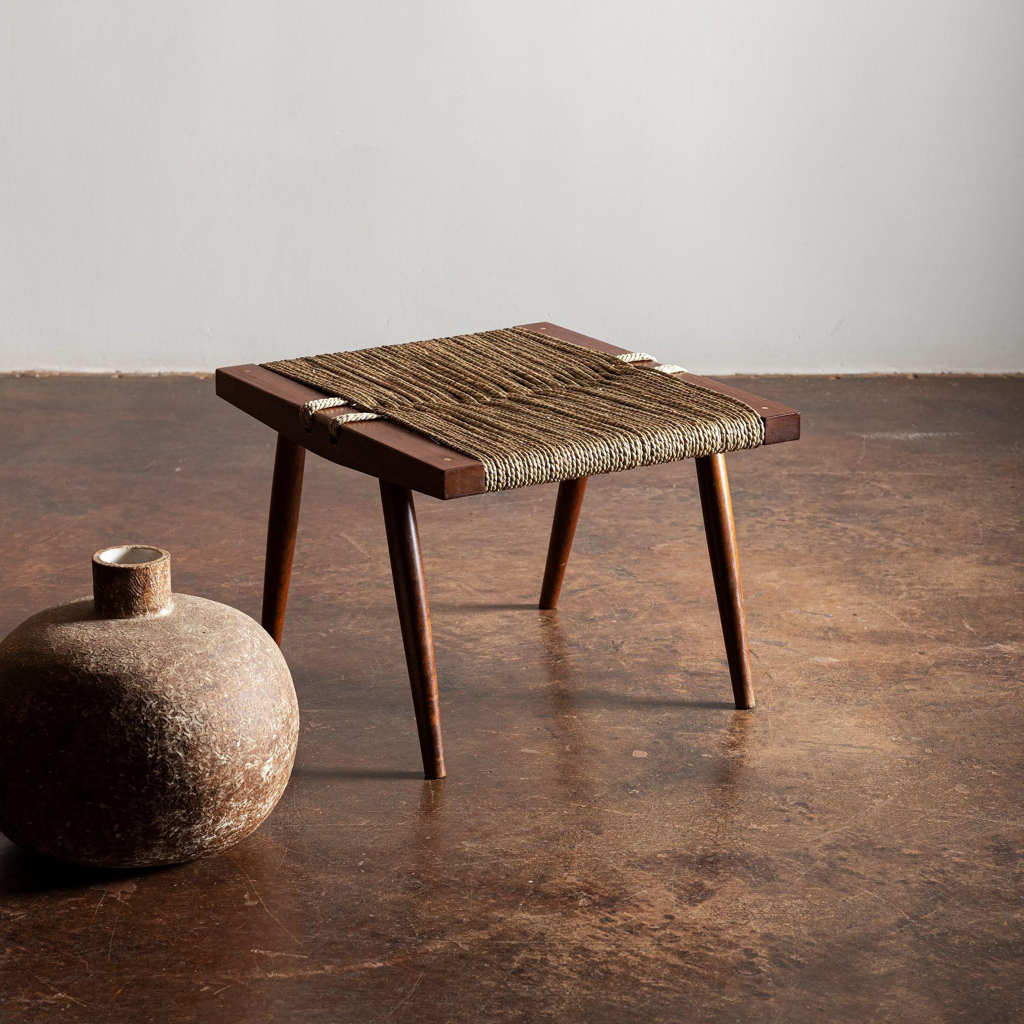 An iconic grass seat stool by George Nakashima. Grass seat recently rewoven at Nakashima Studio.