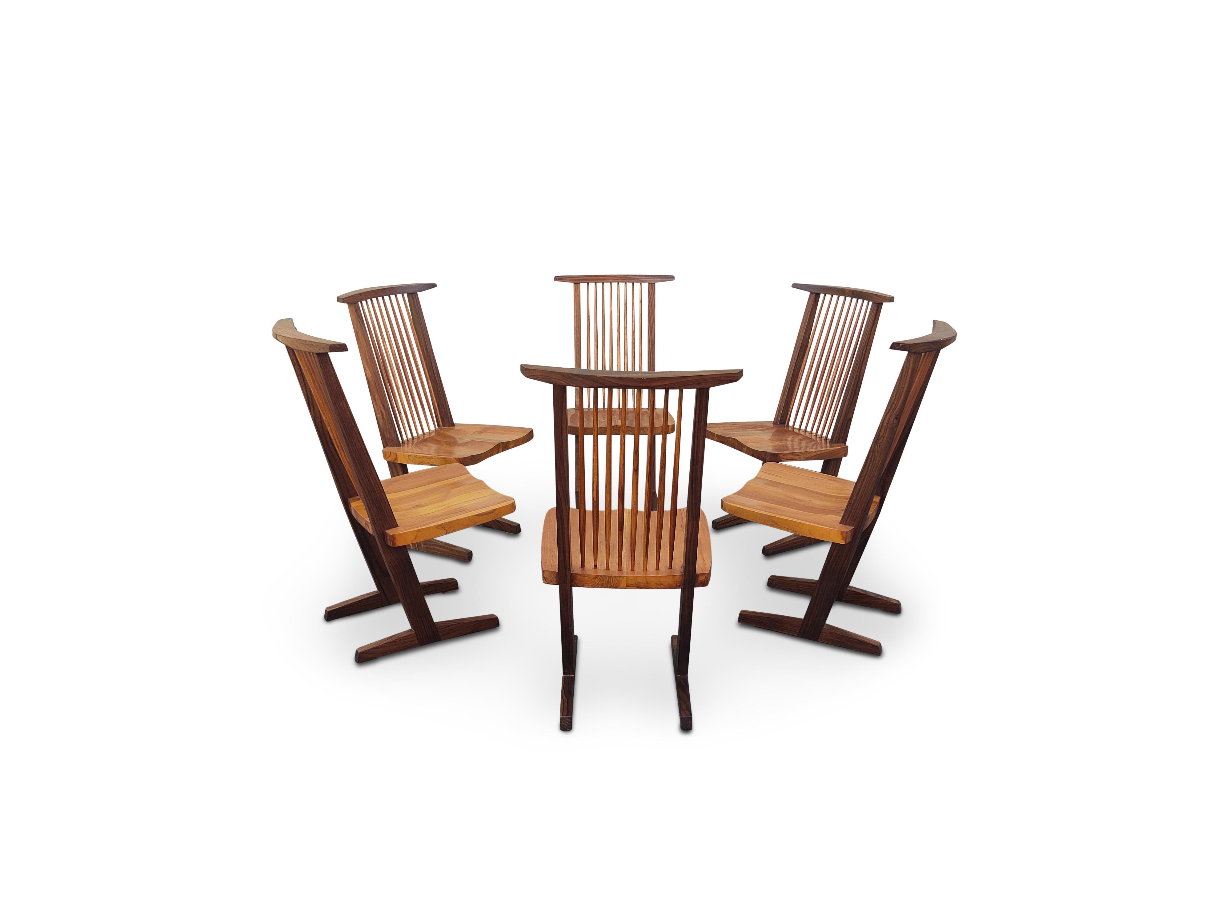 For your consideration, a wonderful set of six, George Nakashima Inspired, Conoid Style dining chairs, likely from the late 70s or early 80s. These chairs are made with mixed hardwoods that have dramatic grain, and a warm patina. They are expertly