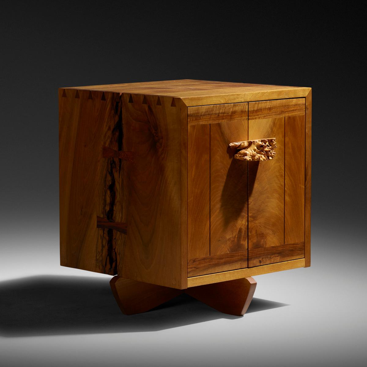 Cabinet features dramatic natural fissures with two rosewood butterflies on each side and one door concealing one adjustable shelf. Signed and dated to the interior of the cabinet 