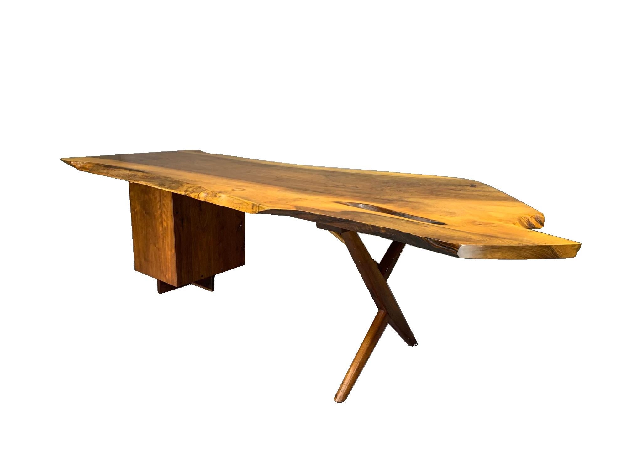 Large writing desk circa late 1950s-early 1960s, made by George Nakashima (1905-1990), New Hope, Pennsylvania, American black walnut, “Conoid” style, with long plank top with polished surface, butterfly joint and finished natural well; freeform