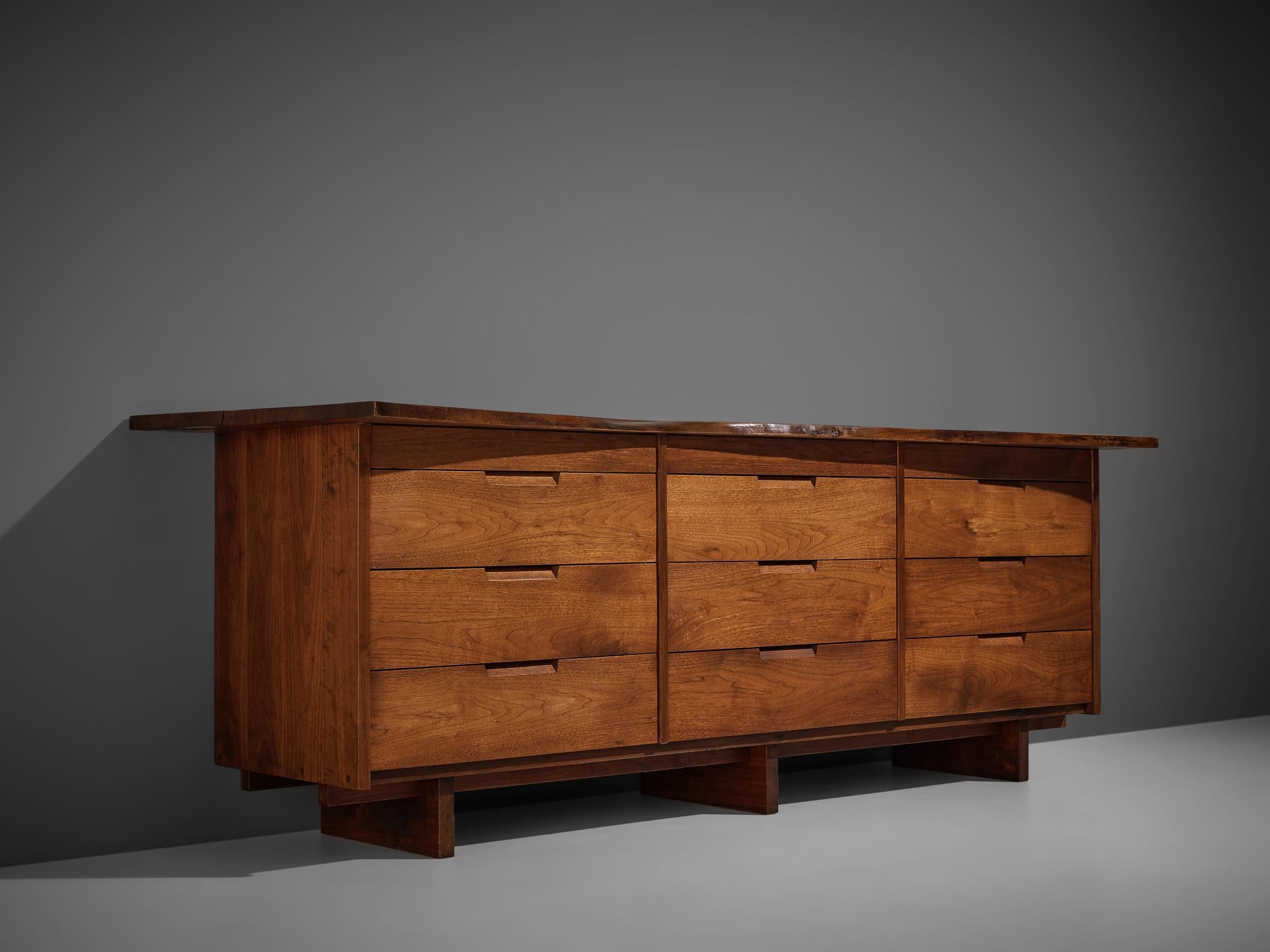 George Nakashima, sideboard, walnut, rosewood, New Hope, PA, United States, 1966

This long sideboard features twelve drawers under a free edge top with overhang. Executed in warm colored walnut this sideboard shows typical Nakashima features like