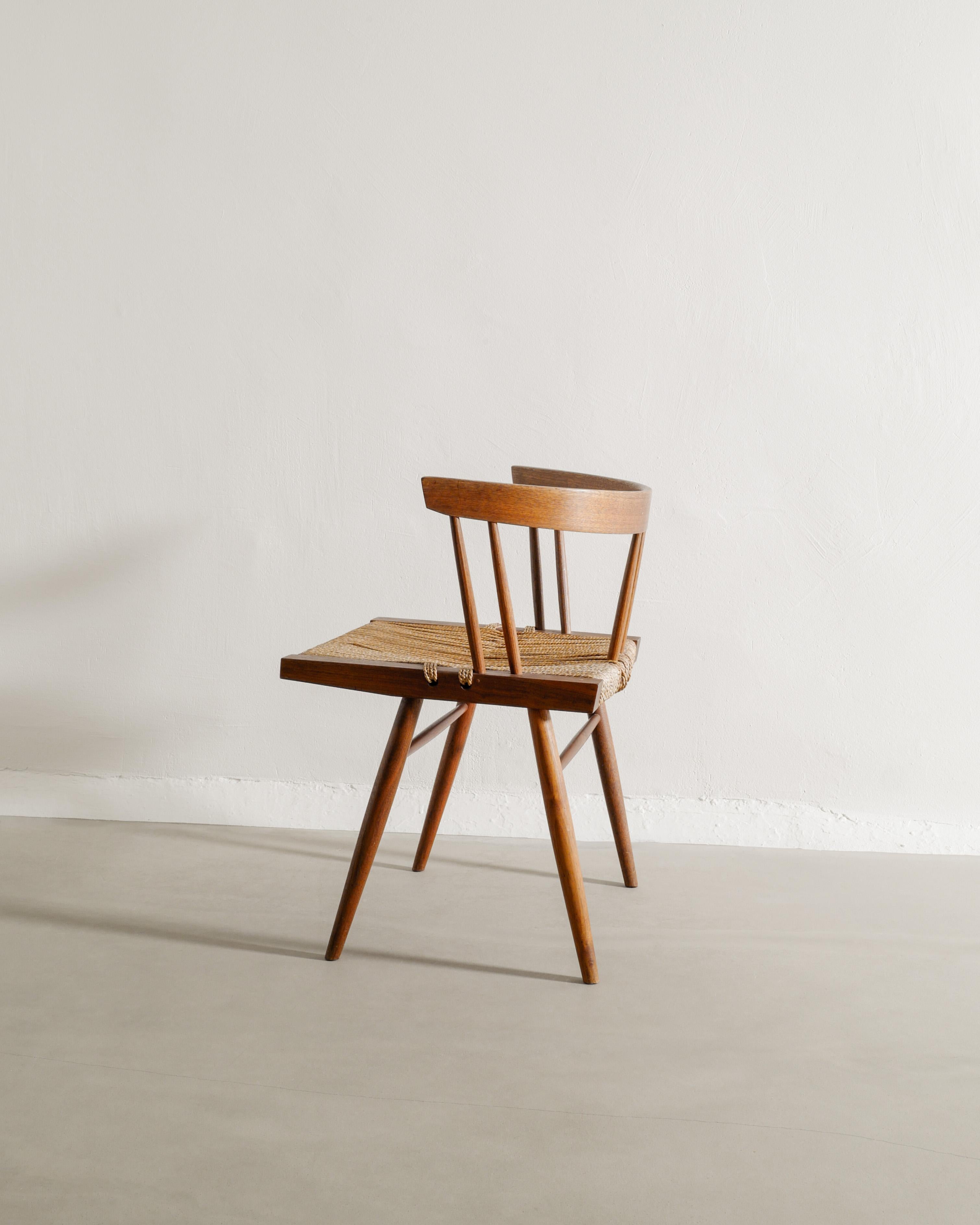 Rare and iconic mid century dining / office chair in walnut wood and grass seating by George Nakashima produced by his studio in United States, 1960s. In good overall and original condition. Some signs of use in the grass seating. 

Dimensions: H: