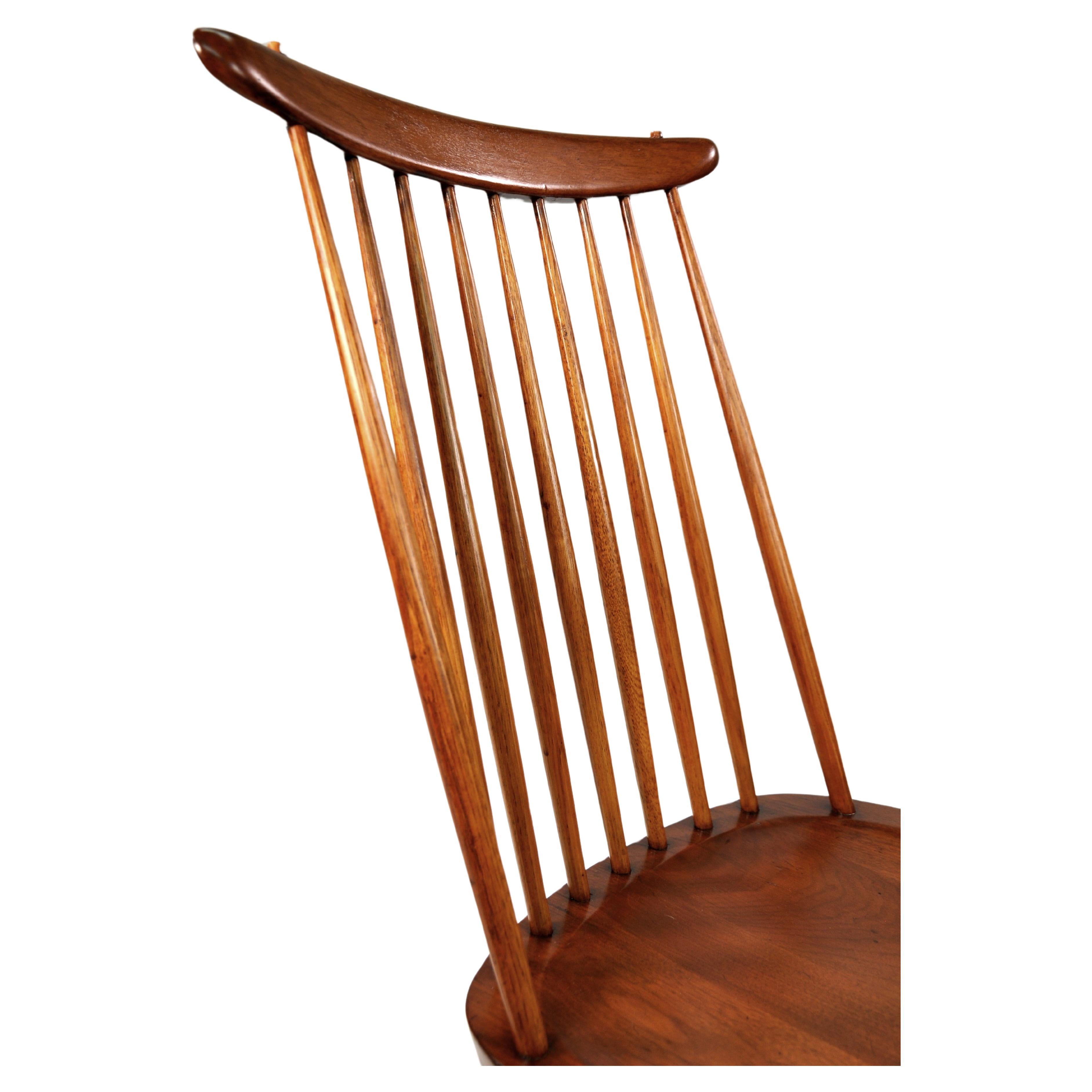 Rare and early model 271 or New Chair, the iconic Windsor spindle back chair reimagined by Japanese-American Master Woodworker, George Nakashima in 1956. East Indian Laurel wood in the original Sundra finish with hickory spindles and sculpted seat.