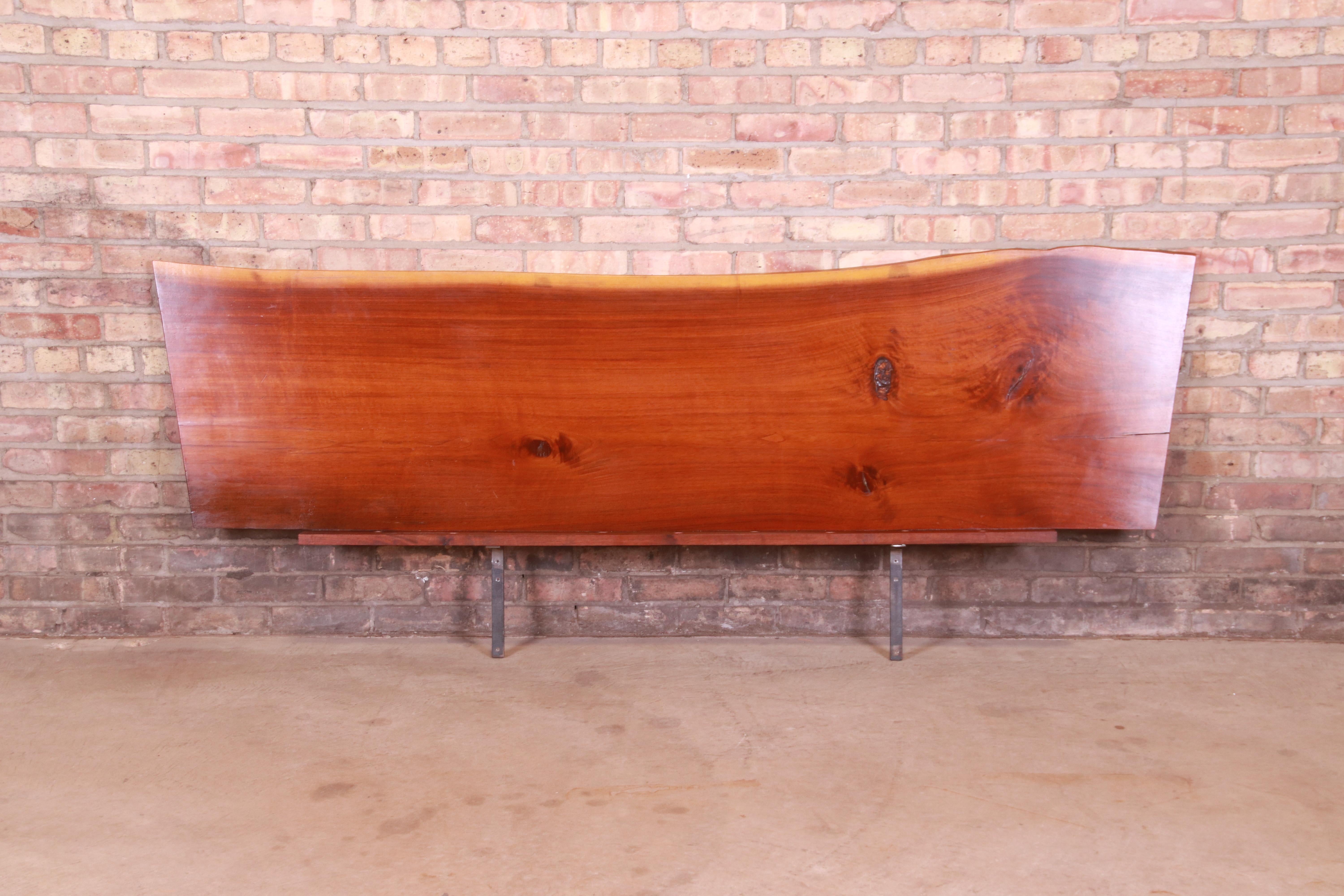 A gorgeous mid-century Organic Modern king size floating headboard

By George Nakashima

USA, 1960s

Hand-crafted from a single slab of walnut in natural tree form, with metal brackets for mounting to the wall.

Measures: 82