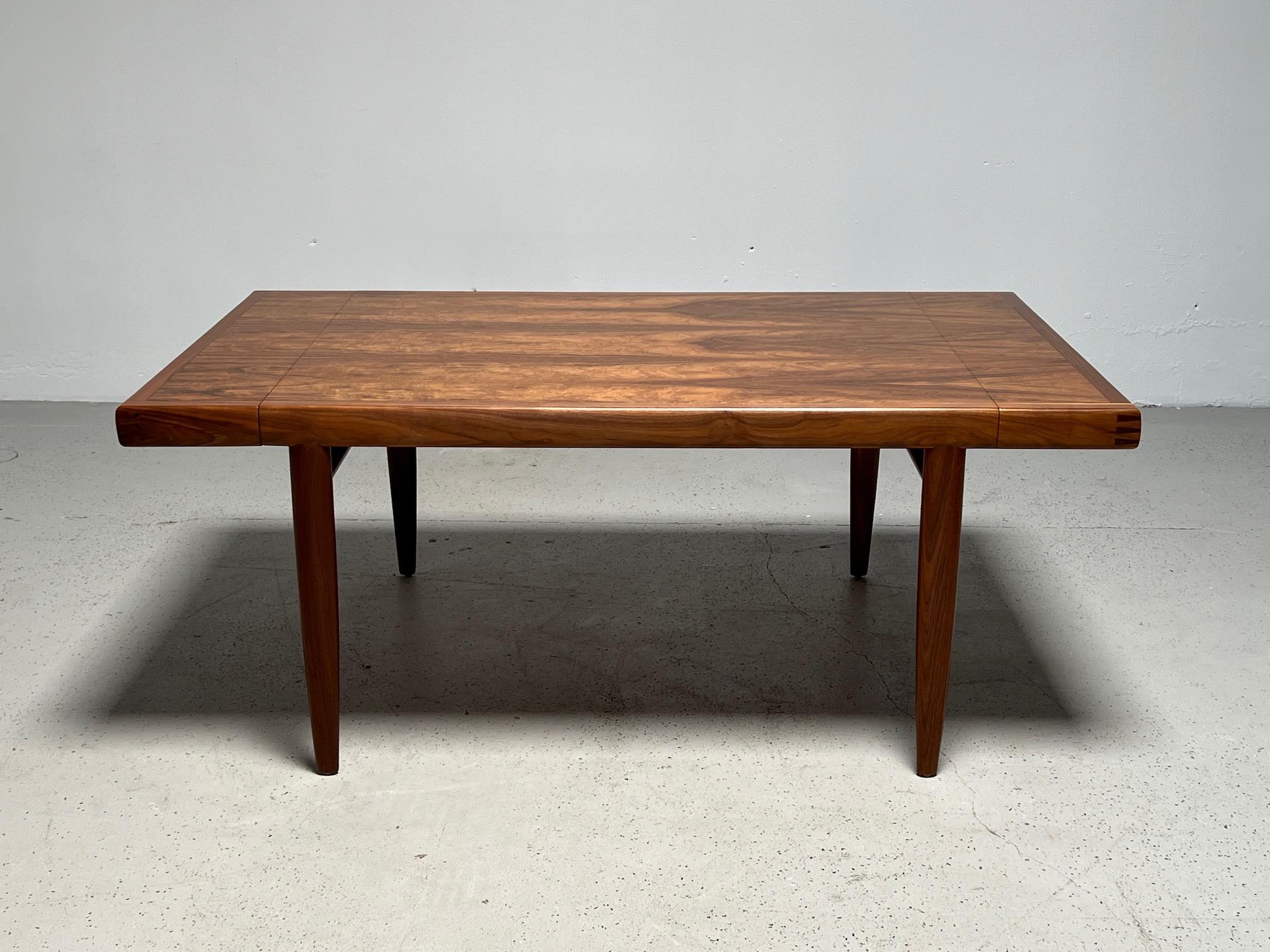 A beautifully grained walnut dining table designed by George Nakashima for Widdicomb. Measurements are with the two 18