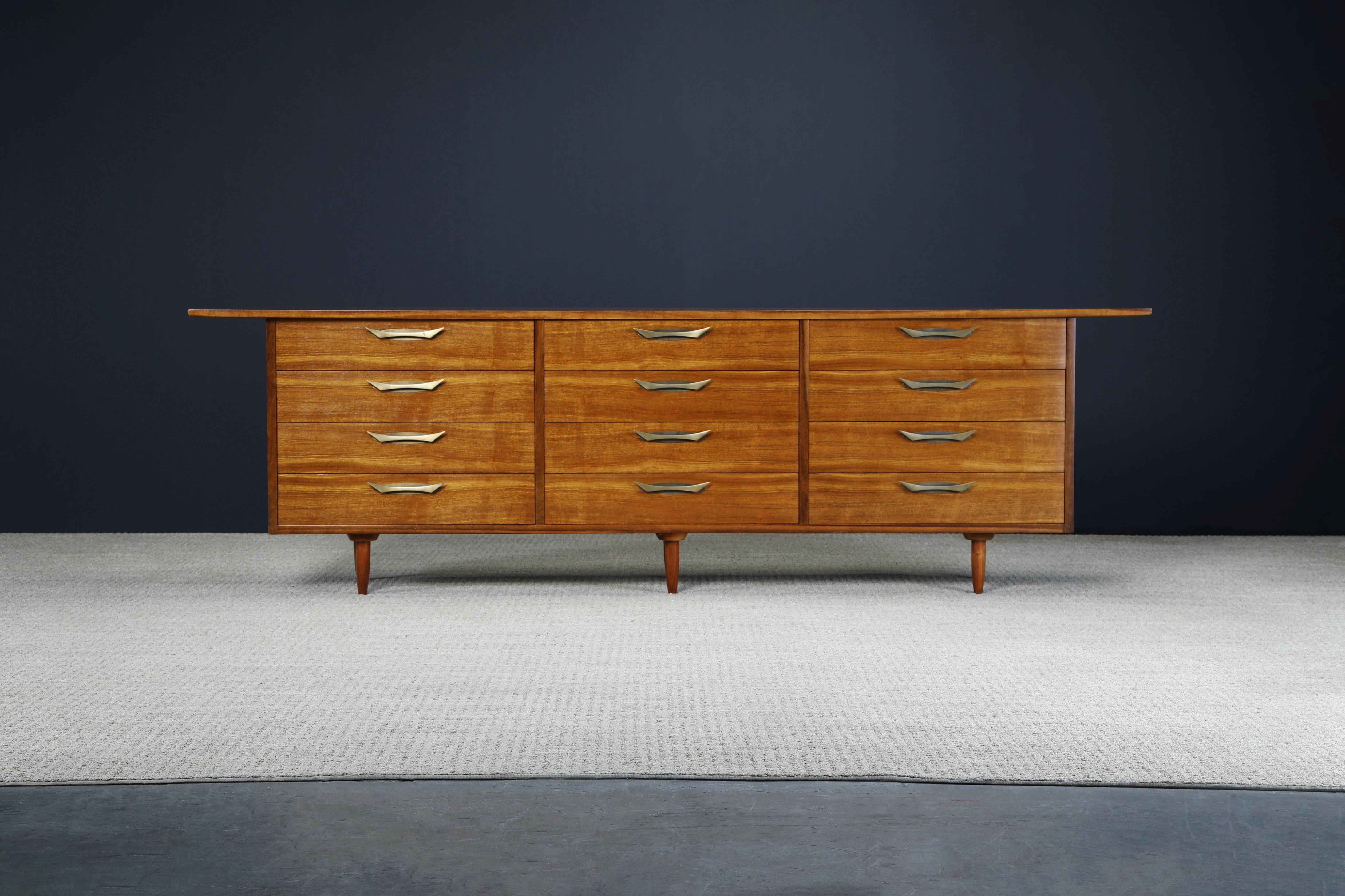 This gorgeous 'Sundra' twelve drawer dresser by George Nakashima for Widdicomb, circa 1960, features beautiful Indian Laurel wood and dramatic large brass handles, which is a much more rare and sought-after variation of this design. Refinished and