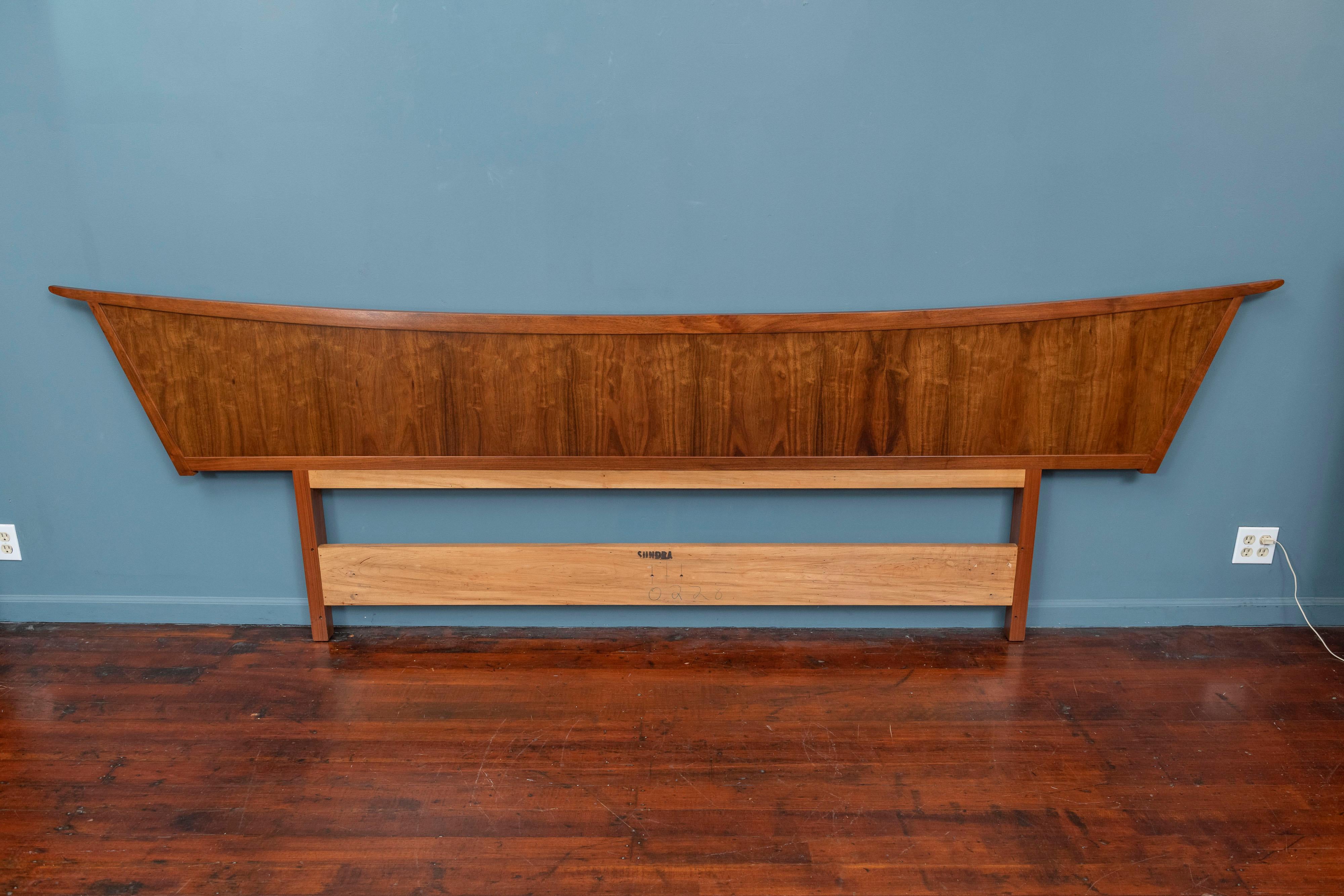 George Nakashima design headboard for a king or queen sized bed for his Origins series by Widdicomb, 1959. Constructed of East Indian Laurel wood in the original Sundra finish, cleaned and waxed and ready to install. The complete bedroom set is
