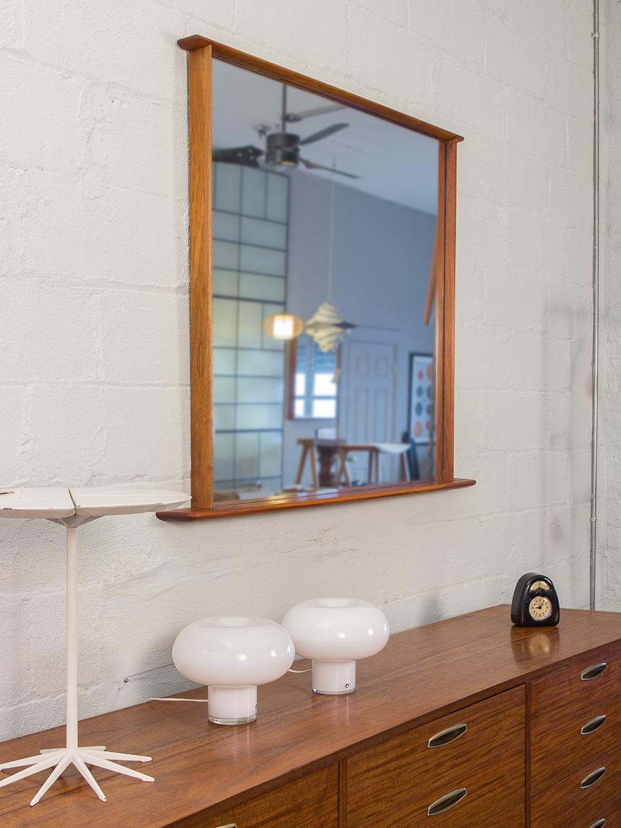 George Nakashima origins mirror. Stunning, substantial wall mirror constructed of solid walnut. Sculpted beams elegantly extend beyond the mirror’s frame. Has been lovingly used, and in excellent vintage condition. Wood is gleaming, and mirror has