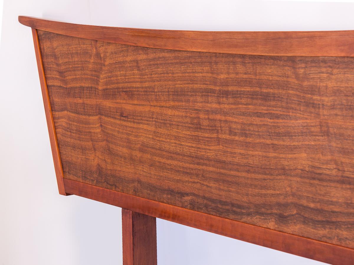 George Nakashima Origins Queen-Size headboard. The headboard features a dramatic, sweeping form that is regal and elegant. Surface is incredibly clean, laurel wood veneer is has a stunning grain whose lines move with the form.

Part of the