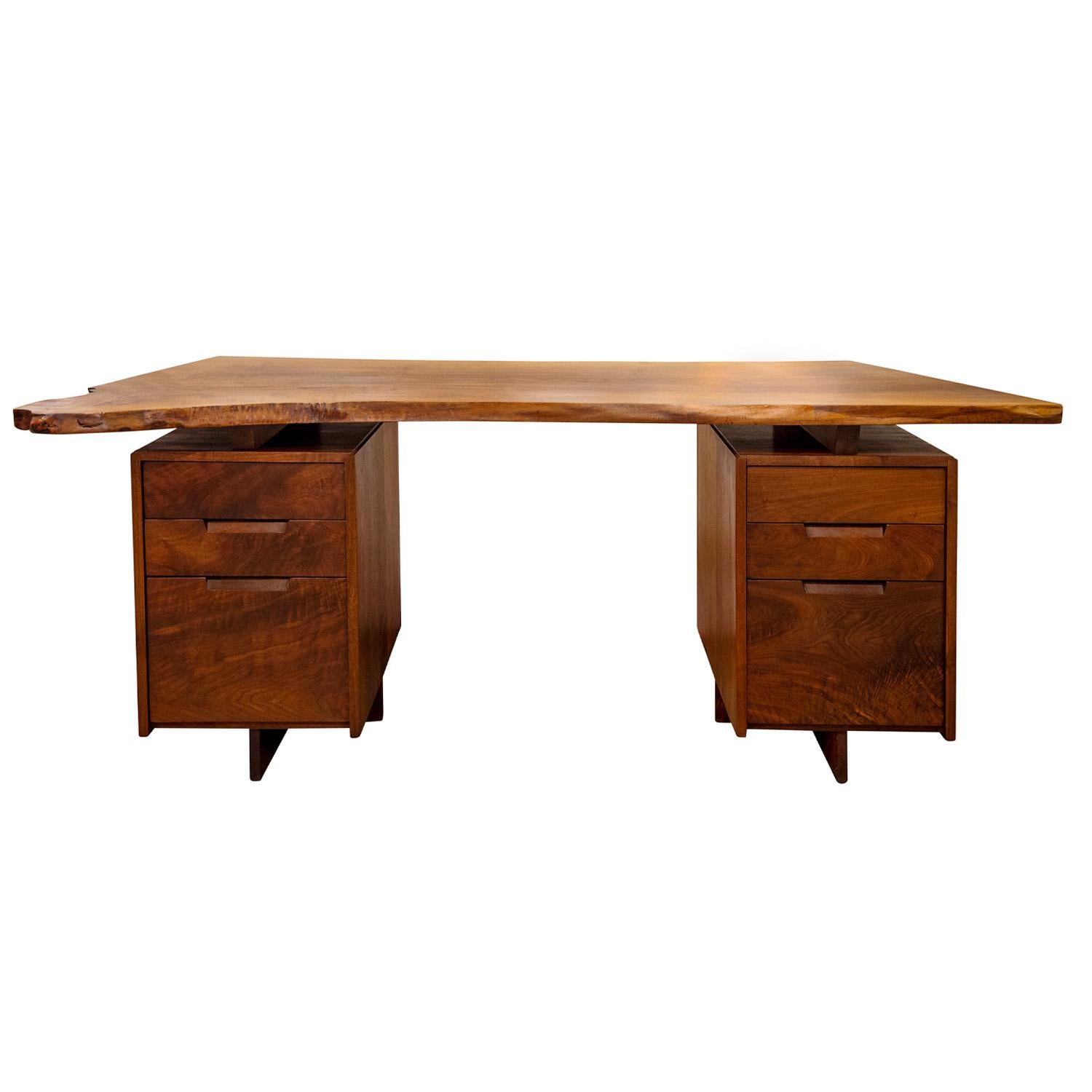 Rare double pedestal desk with free edge top in walnut with rosewood butterfly on top by George Nakashima, American 1950's (name of client “COX” written in marker on bottom of top). Each one of these pieces was custom made for it’s owner, and as